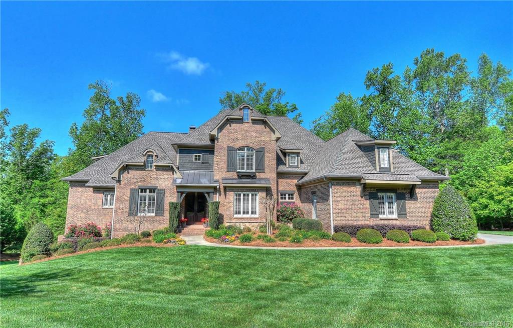 Elegant floor plan features beautiful hardwoods, custom moldings, plantation shutters & surround sound.Gorgeous gourmet kitchen opens to a 2-story great room w/fireplace.A cathedral ceiling & luxury bath highlight the main level owners retreat.Main level guest suite & large bedroom suites that open to a bonus room upstairs.Finished lower level offers a family rec space & secondary living expansion.A screened porch w/fireplace & flagstone terrace overlook wooded privacy & the 13th tee & fairway.