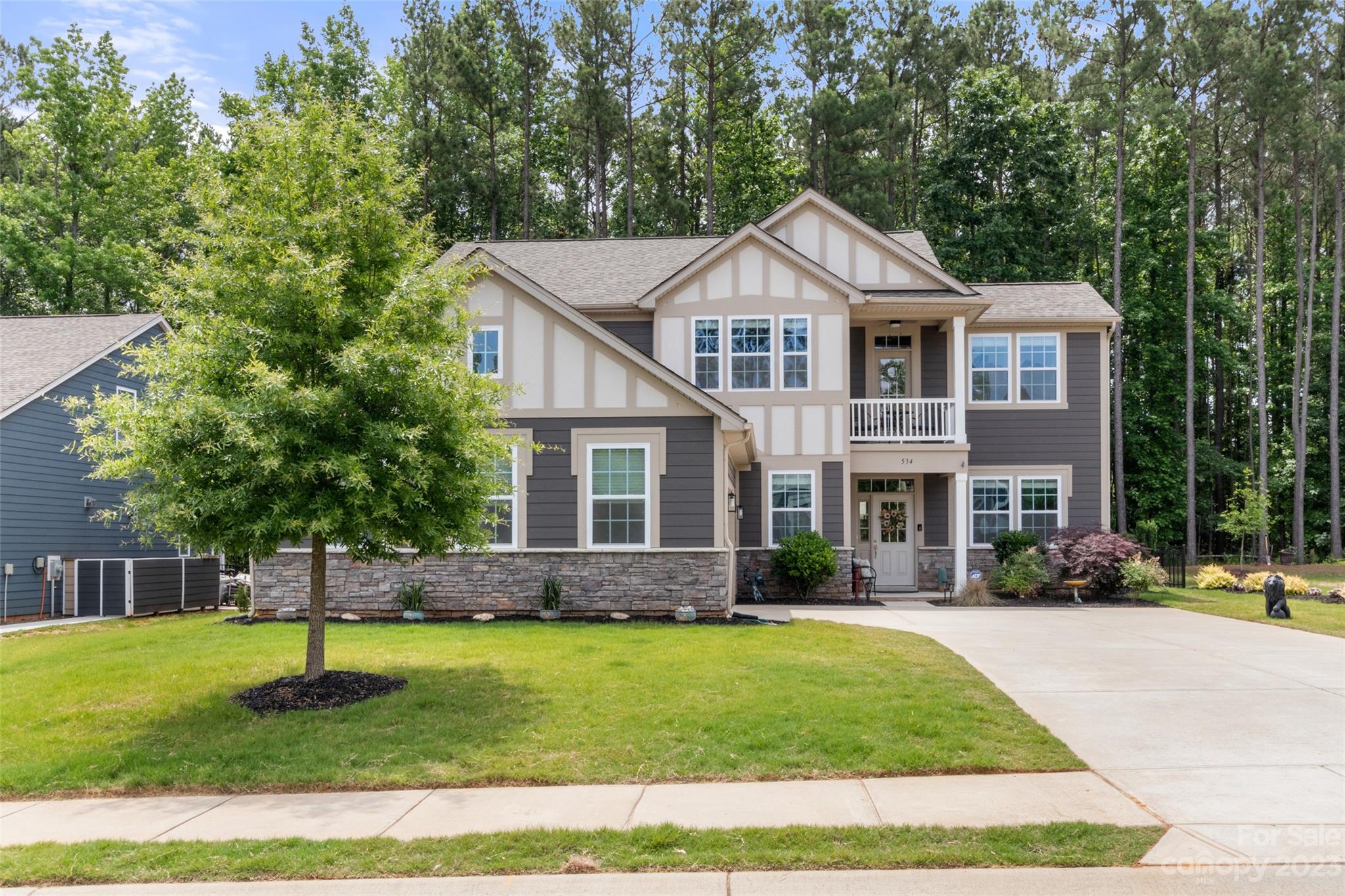 WELCOME to your new home just minutes from Lake Wylie!  Enjoy the open space in this beautiful home as soon as you walk in the front door.   Gourmet kitchen with large granite island/breakfast bar opens to a great room with a fireplace that looks out onto a private fenced in backyard.  An added feature is an office niche off the kitchen for working at home or home working!  Downstairs bedroom suite with full bathroom is conveniently located to provide privacy for a guest or family member.  The upstairs primary bedroom suite includes a covered balcony for your breakfast coffee time or star gazing.  Two other upper bedrooms and a loft creates even more comfortable living space.  Sellers have upgraded the upstairs with hardwood flooring, the kitchen with bright cabinets, the outside living area with an extended patio and installed an air filtration system on the HVAC unit.