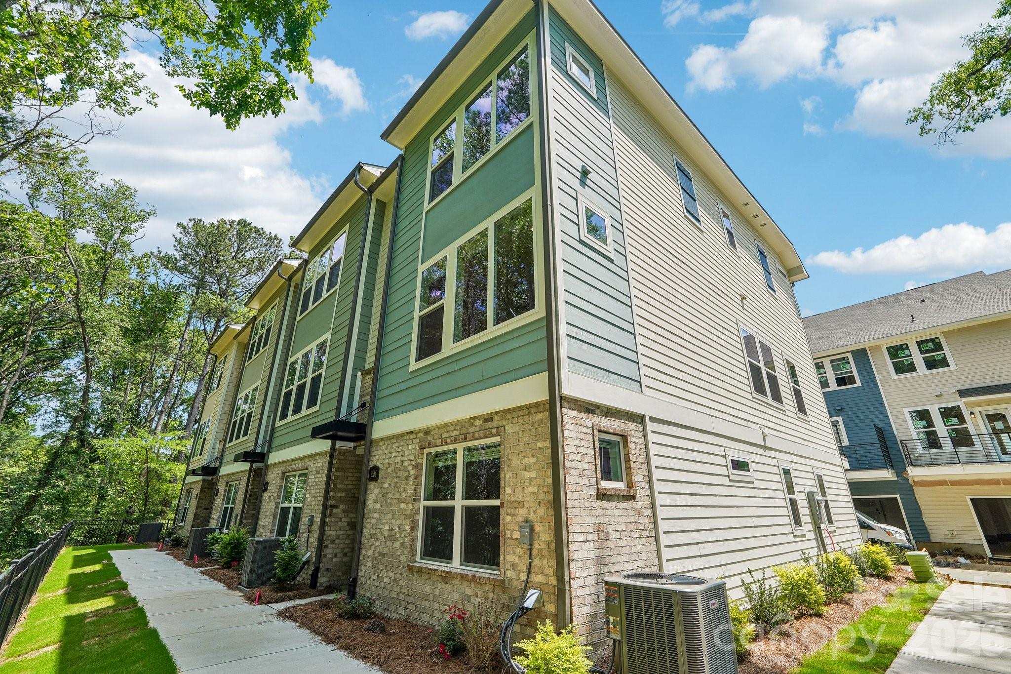 Discover this stunning 3-bed, 3-bath townhome, perfectly positioned on a prime tree-lined homesite with wooded views. Enjoy elevated living with a spacious balcony, 9-foot ceilings, and an expansive kitchen island ideal for entertaining. Ground level suite perfect for guests with direct bath access.  Designed for comfort and efficiency, this home features energy-saving construction, luxury vinyl plank flooring, and signature David Weekley oversized windows that fill every room with natural light. The kitchen is beautifully appointed with Frigidaire Gallery appliances, blending style and performance in every detail.