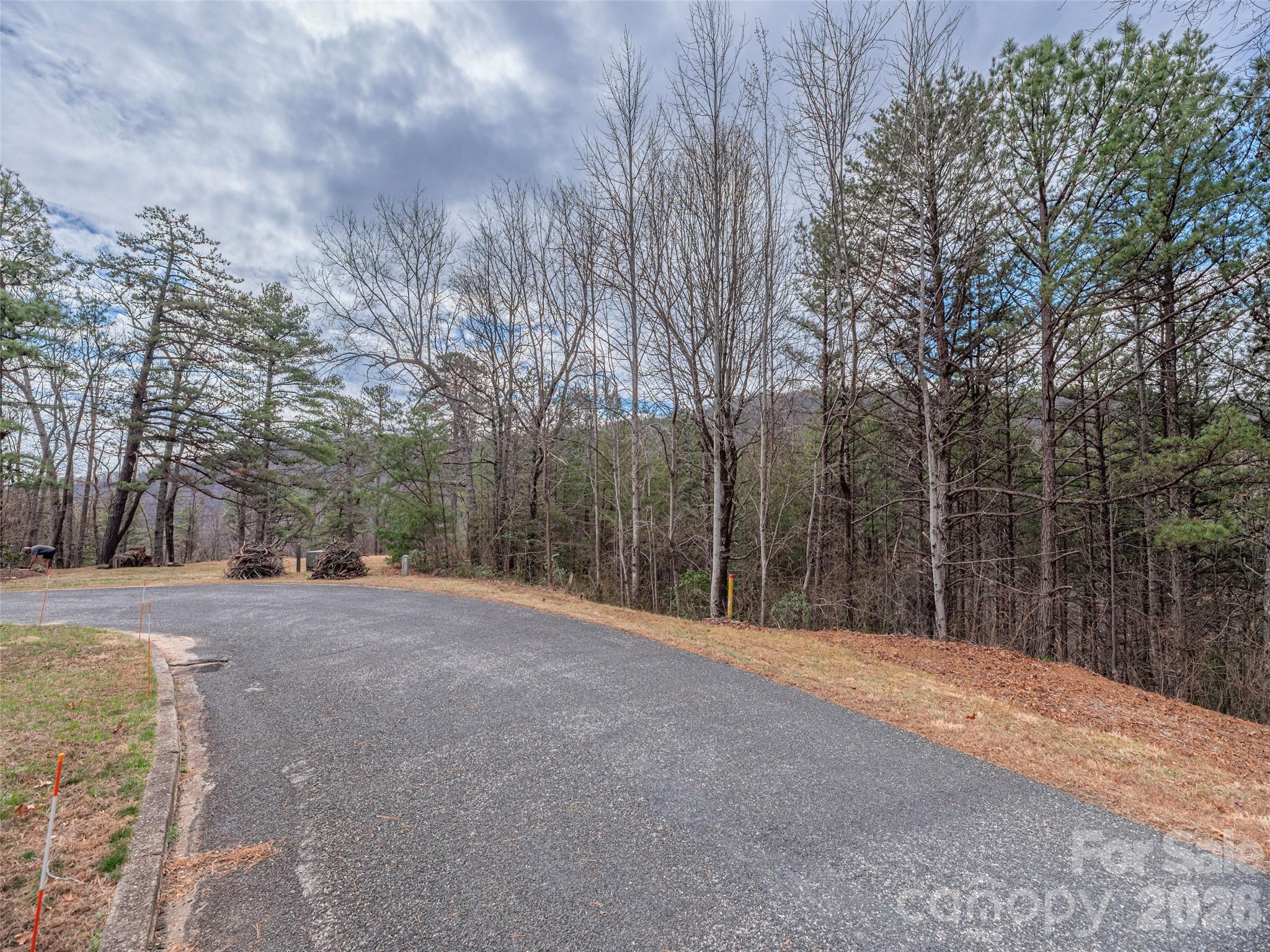 Premier Building Opportunity in Creston! Located on the first side street within the gated community, this 1.7 acre parcel offers exceptional ease of access and end of cul-de-sac privacy. The lot features a gentle, rolling topography along the upper portion near the road then transitions into a more moderate slope towards the southwest. With selective tree trimming, a future owner can enjoy beautiful distant mountain views. The approach to the property is very convenient, situated on a level street with paved access directly to the lot. Residents of Creston enjoy a robust amenity package including a gazebo with a firepit, a playground for children, multiple mountain overlooks, a dog park, eight miles of hiking trails, twelve miles of paved roads, a mountain top Community Center, and to help keep you connected high-speed fiber optic internet service provided by Spectrum. The land surrounding Creston is in Foothills Land Conservancy and Pisgah National Forest, creating an incredible natural environment. This "C" lot allows for short-term rentals (7-night minimum), making it a versatile choice for a secondary residence or a private mountain retreat. Located just 9 miles from the charming town of Black Mountain and a short 15-mile drive from the vibrant city of Asheville.