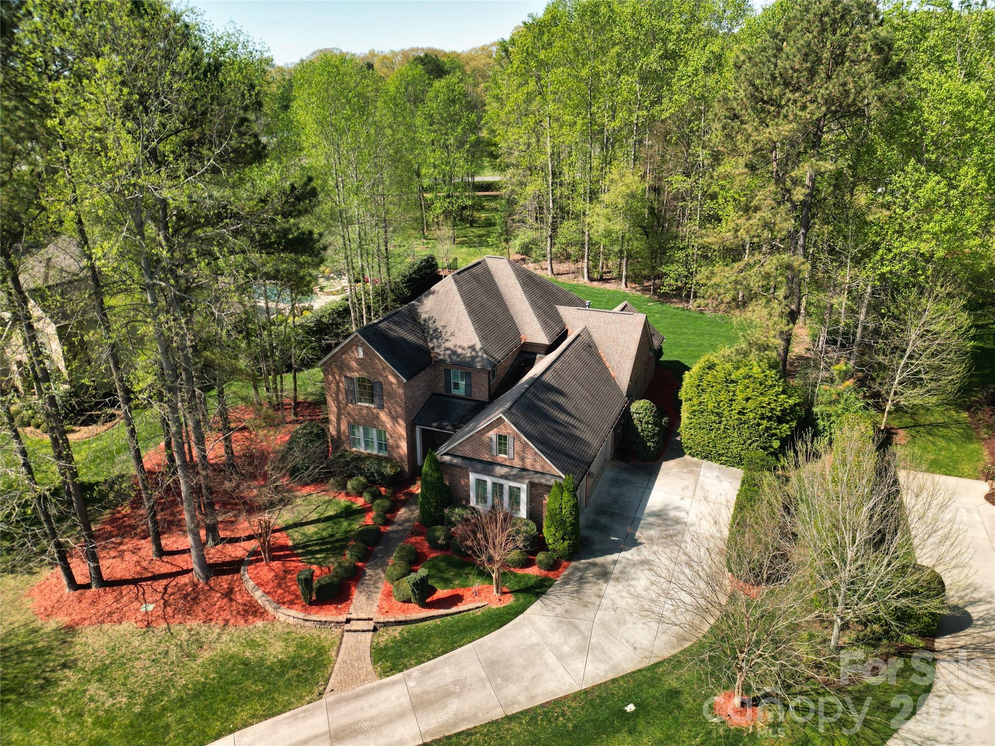 Welcome to this exceptional all-brick Classica home, built in 2013 and nestled on a rare, private 0.74-acre homesite surrounded by mature trees in the prestigious equestrian community of Cheval. Designed with both luxury and flexibility in mind, this remarkable home offers an ideal layout for multi-generational living, a live-in nanny, private guest accommodations, an executive home office, or even the ultimate recreation space.
The unique two-story flex house features its own kitchenette, sitting area, bedroom, and full bath on the main level, while the primary suite is also conveniently located on the first floor and boasts a spa-inspired bath and oversized walk-in closet.
The heart of the home is perfect for entertaining, with an open-concept kitchen, dining, and living area that seamlessly extends through sliding glass doors to a covered lanai, making outdoor gatherings enjoyable rain or shine. Upstairs, you'll find four additional spacious bedrooms, three full baths, and a large bonus room currently serving as a billiards room.
Thoughtful upgrades throughout include plantation shutters, built-in audio, multi-zone irrigation, and an oversized epoxy-coated garage. The professionally landscaped yard offers beauty and privacy while remaining easy to maintain.
Cheval is one of the area's most sought-after communities, featuring estate-sized homesites, scenic riding and walking trails, and a peaceful setting just minutes from shopping, restaurants, and I-485. This is a rare opportunity to own an extraordinary home that offers exceptional space, versatility, and value in one of the region's premier neighborhoods.