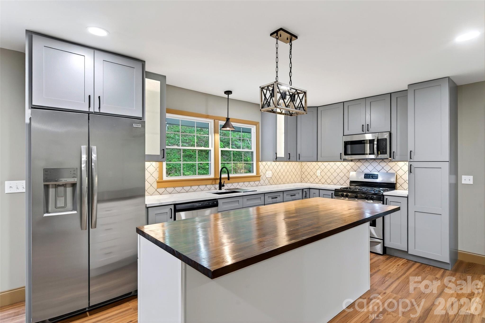 Tucked away on over 9 private acres in the mountains of Bakersville, this  beautifully renovated upscale home offers the perfect pairing of privacy and convenience. With 5 spacious bedrooms and 3 stunning bathrooms, every inch of this home has been thoughtfully redesigned with modern comfort in mind.

The show-stopping kitchen is truly the heart of the home, featuring stylish cabinetry, premium finishes, abundant workspace, and an open layout ideal for entertaining and everyday living. The three full bathrooms are equally impressive.

Step outside and soak in the peaceful mountain setting from your private hot tub, included with the home — the perfect place to unwind  after a day of work or a long day out exploring the mountains. 

Enjoy the serenity of mountain living while still being just minutes from the Appalachian Trail and within approximately an hour of both Johnson City and Asheville. A garage adds practicality and storage, while the expansive acreage gives you room to roam, relax, or simply enjoy the  surroundings.

Sure, you could buy land and spend the time, money, and stress building a new home — or you could move right into this completely transformed property for under $200 per square foot. Upscale mountain living without the wait.