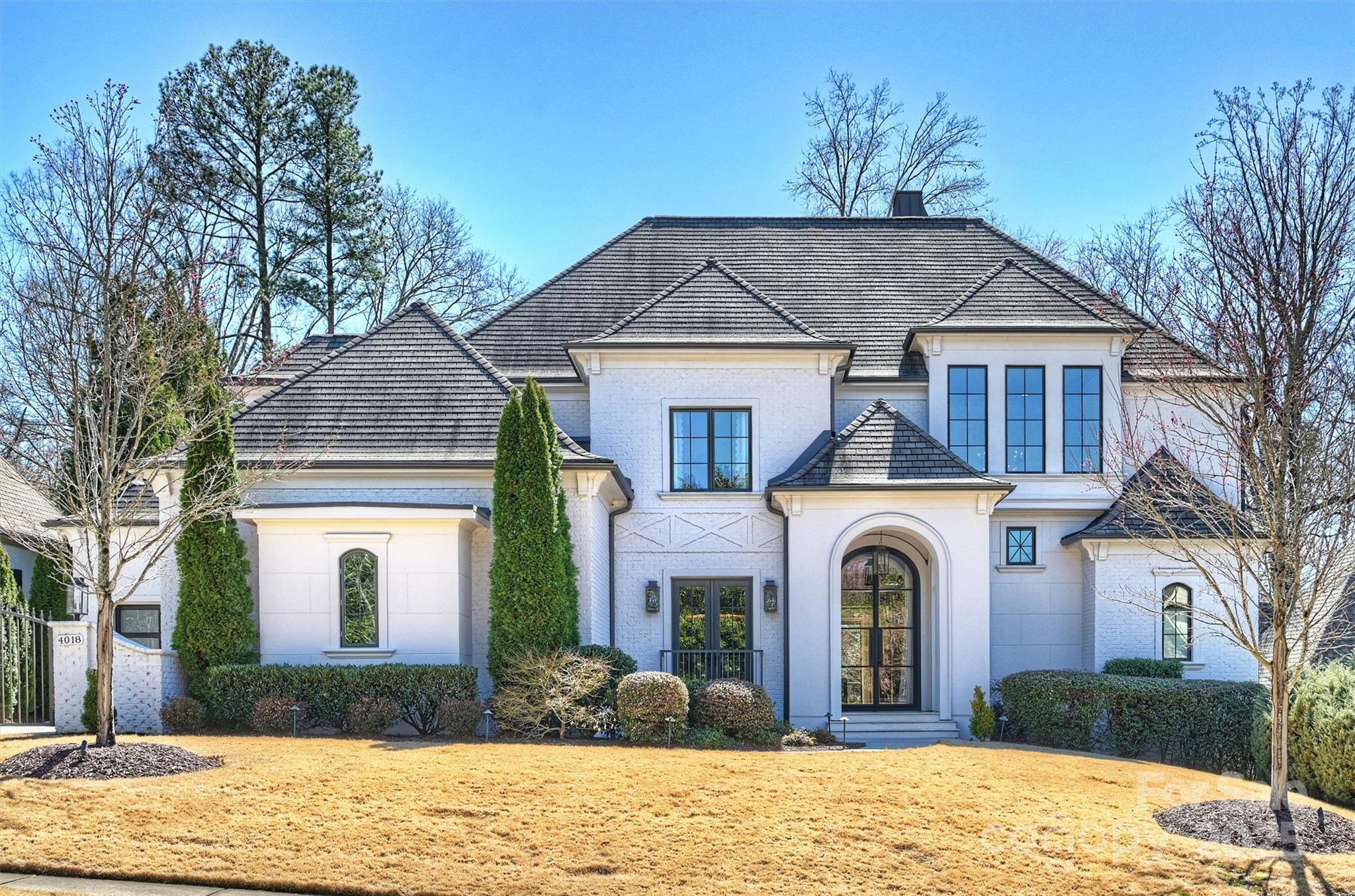 Nestled in a quiet neighborhood, this custom Kingswood home offers modern luxury, convenience, and security. A whole-home Savant system, Lutron lighting, and premium sound system create effortless control. Renovated in 2018 the home features high-end finishes and seamless indoor-outdoor living. At the heart of the home, the stunning kitchen showcases a Majestic range and opens to a beautiful informal dining area featuring a tailor-made banquet. Elegant lighting accents every space. Temperature & humidity-controlled 650-bottle wine cellar, whole house generator and water filtration system. Outdoors, enjoy a putting green, playground, and infinity pool, or relax on the covered terrace. The main level primary suite is a true retreat- its spa-like bath has heated floors, a steam shower and custom closets. The second level  provides a lounge, a gym, and a home theatre. A rare opportunity to own a turn-key luxury home in an unbeatable location near SouthPark in the Quail Hollow area.