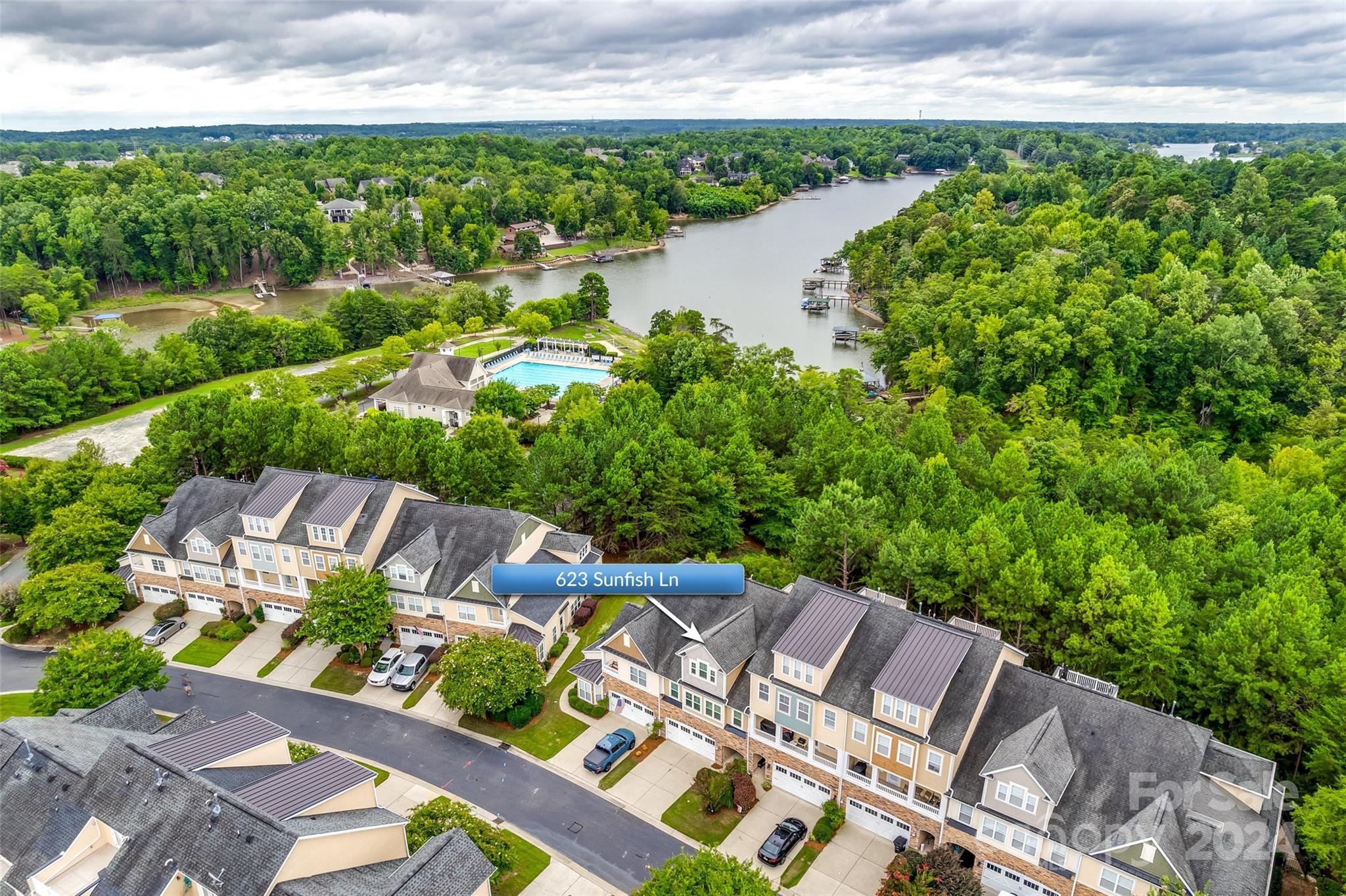** 1 Year Paid HOA dues as a seller concession! ** This 3 bedroom/2.5 bathroom townhouse is located in the Beach Club community of Lake Shore on Lake Wylie. Inside, the open floor plan welcomes all of the Carolina sunshine through large windows & double glass doors leading out to the patio. A cozy gas fireplace with built-in shelving surrounding it. Upstairs, the spacious primary bedroom features a trey ceiling, private balcony & ensuite with double sinks, a large soaking tub & a separate shower plus a large walk in closet. Two additional bedrooms & a full laundry room are on the second floor. The third-story offers a huge bonus room (or potential 4th bedroom!) & rooftop terrace! Windows were replaced in 2023. The neighborhood offers miles of scenic walking trails, outdoor pool, clubhouse and fitness center offer endless opportunities for relaxation & activities right at your doorstep. Home is vacant with fresh paint, carpets were just deep cleaned, and it's move in ready!