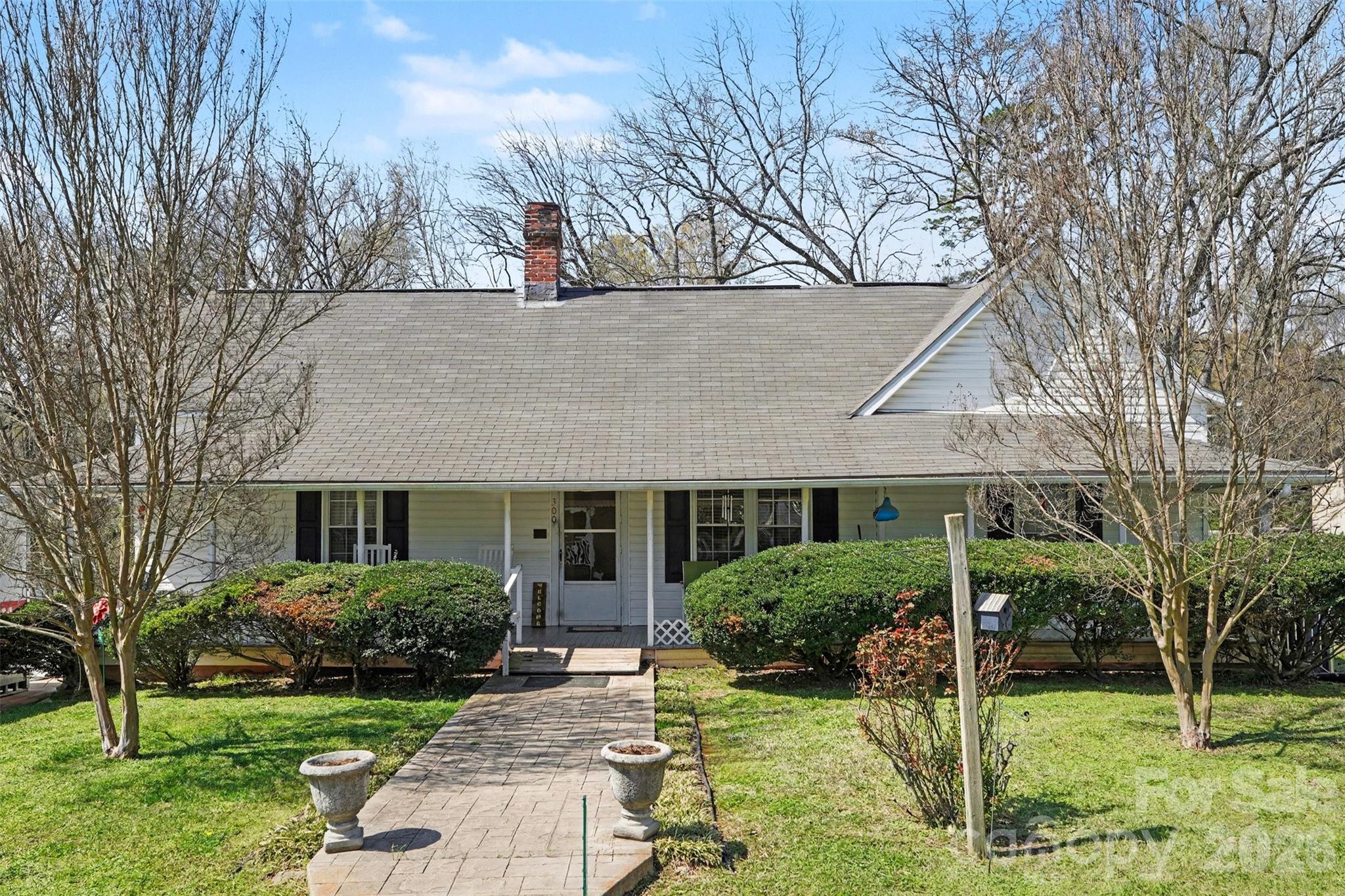 Charming Century-Old Gem in the Heart of Waxhaw. Step back in time with this 1920s single-story home located just blocks from the vibrant Historic Waxhaw district. Spanning over 1,688 square feet, this 2-bedroom, 2-bathroom residence offers the perfect blend of small-town nostalgia and modern convenience. Situated on a generous 0.35-acre lot, the property provides ample outdoor space for gardening or entertaining, all within walking distance of local shops, dining, and the iconic overhead pedestrian bridge. Whether you’re looking for a cozy primary residence or a unique restoration project, this home captures the classic North Carolina small-town spirit.  This home is part of the Historic Registry of Waxhaw.
