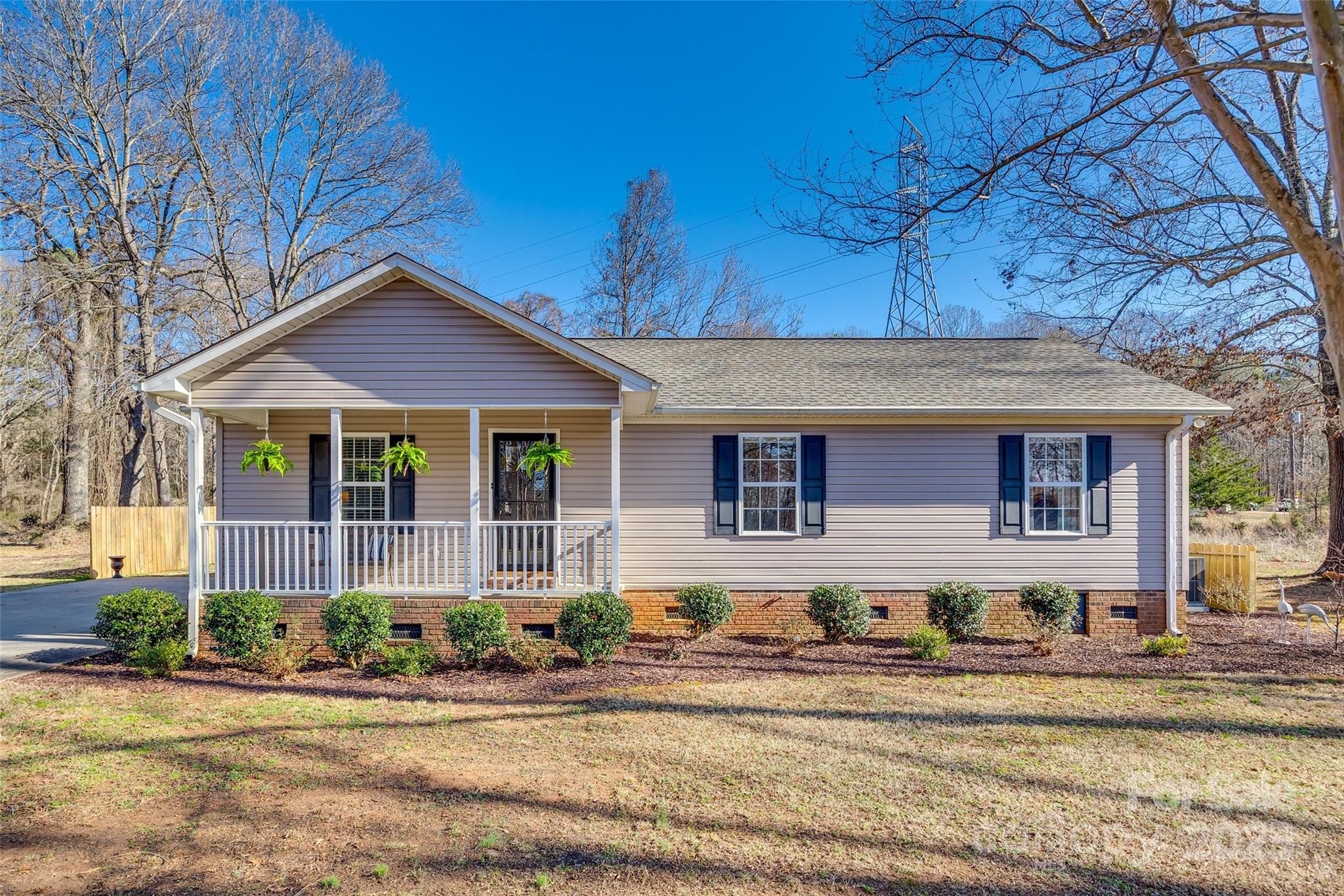 Nestled on a serene half-acre lot, this meticulously maintained ranch home offers a peaceful retreat while remaining close to the charm of historic downtown York and York Comprehensive High School. The inviting rocking chair front porch provides a perfect place to relax, while the screened-in back porch offers a private oasis for enjoying the outdoors in comfort. Inside, the home features three spacious bedrooms and two full bathrooms, with beautiful vinyl plank flooring throughout. The modern kitchen boasts sleek granite countertops and stainless steel appliances, making it a true focal point. A wired barn/shed adds practical storage space, ideal for hobbies or projects. With its combination of privacy, convenience, and thoughtful updates, this property is the perfect place to call home.