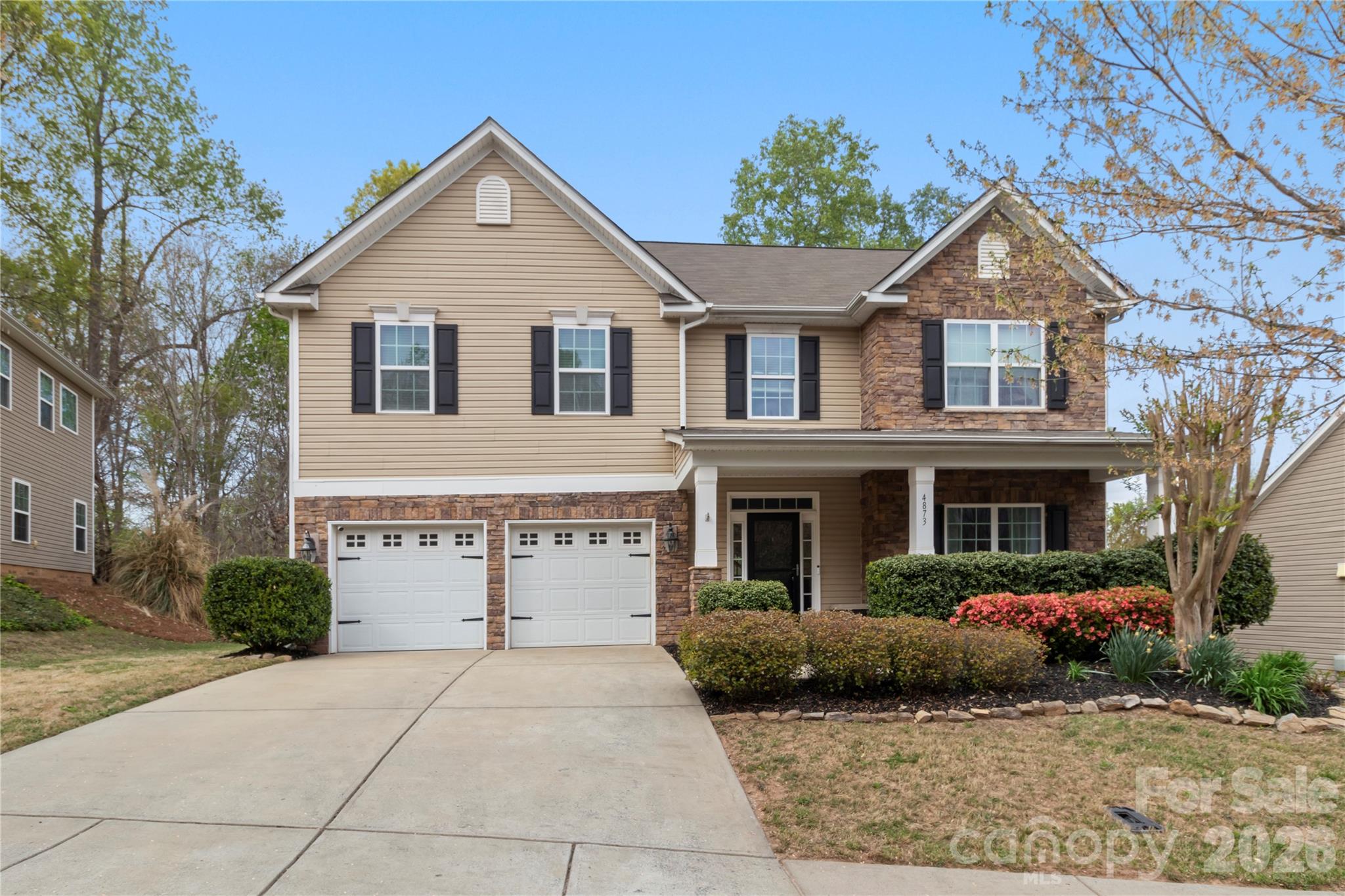 Welcome to this amazing home in the highly desirable Stowe Pointe neighborhood of Belmont.

Coming down the street, you will be guided by tree-lined sidewalks and greeted by beautiful landscaping and a welcoming covered front porch.   

Inside, the open floor plan offers plenty of space and light. The spacious kitchen features a large island, while a beautiful front room with french doors gives you a dedicated workspace or flex space. Enjoy a large living room with gas logs and beautiful faux stone flooring throughout and a separate formal dining room! 

Upstairs you will find BRAND NEW CARPET! The enormous primary suite features a dramatic tray ceiling and sitting area, and the oversized secondary bedroom easily doubles as a bonus room.

The property has been carefully landscaped and the stone patio out back overlooks a densely wooded forest- offering privacy and tranquility that is somewhat of a rarity in this area. 

A healthy mix of privacy with an abundance of convenience with Chic Fil A, Harris Teeter and other shopping just around the corner. The neighborhood pool and playground are just steps away! Vibrant downtown Belmont is just minutes away! Plus, you're conveniently located near I-85, I-485, and Charlotte Douglas International Airport.
This home checks every box. Don’t miss out—make it yours today!