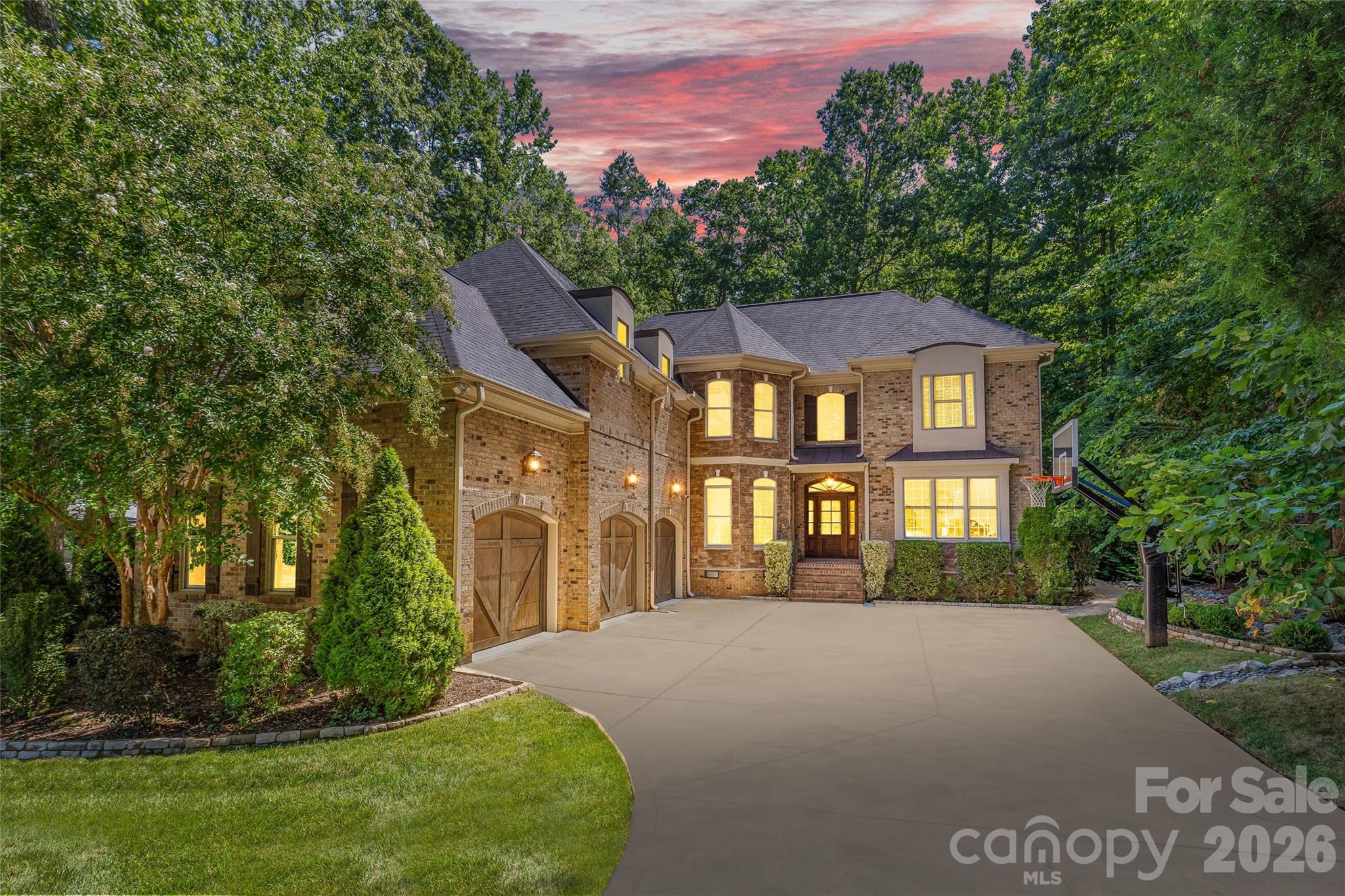 Welcome to 3030 Ashford Glen Drive, a beautifully renovated brick estate tucked away at the end of a private cul-de-sac in Highgate, a desirable luxury neighborhood in Weddington. Set on 1.14 acres, this exceptional residence offers approximately 4,500 square feet, 5 bedrooms, and 4.5 baths, beautifully updated with timeless design and today's luxury finishes.

A circular driveway and tranquil front-yard fountain welcome you home, while mature trees create a private setting that feels tucked away from it all. Beyond the foyer, a modern staircase makes an immediate impression as premium engineered hardwood flooring, freshly painted interiors, custom board-and-batten millwork, elegant crown molding, and thoughtfully selected lighting create a warm, refined aesthetic. An abundance of natural light fills the open floor plan, creating bright, inviting spaces designed for everyday living and effortless entertaining.

At the heart of the home, the chef's kitchen features an oversized 10-foot island, custom white cabinetry, a built-in Sub-Zero refrigerator, a six-stage reverse osmosis water system, and remote-controlled roller shades. The kitchen opens seamlessly to the main living and dining areas, offering an ideal layout for gathering, hosting, and everyday living. A private home office with a custom glass door and designer accent wall, illuminated built-ins, and a spacious bonus room provide exceptional flexibility.

The expansive primary suite is a true retreat, showcasing a newly renovated spa-inspired bath with a freestanding soaking tub, oversized dual-head walk-in shower, custom vanity, and floor-to-ceiling designer tile.

Extensive updates include a new roof (2024), new tankless water heater, new metal gutter guards, newer second-floor HVAC (2022), app-controlled irrigation, and a comprehensive Vivint security system with seven cameras and glass-break sensors.

The finished garage is a standout feature, complete with commercial-grade epoxy floors, custom cabinetry and workstation, a vehicle lift, a 60-amp Tesla charger, upgraded doors with whisper-quiet rollers, striking LED honeycomb lighting, and a mounted 78-inch television.

Designed for entertaining, the private, level backyard features an expansive paver patio, outdoor kitchen, outdoor fireplace, and plenty of room to add a custom pool, pool house, or cabana. The neighborhood's scenic walking trails and peaceful pond are accessed directly from the cul-de-sac.

Just minutes from Waverly, Rea Farms, and Blakeney, this exceptional home offers the perfect balance of luxury, privacy, and convenience in the heart of Weddington.
