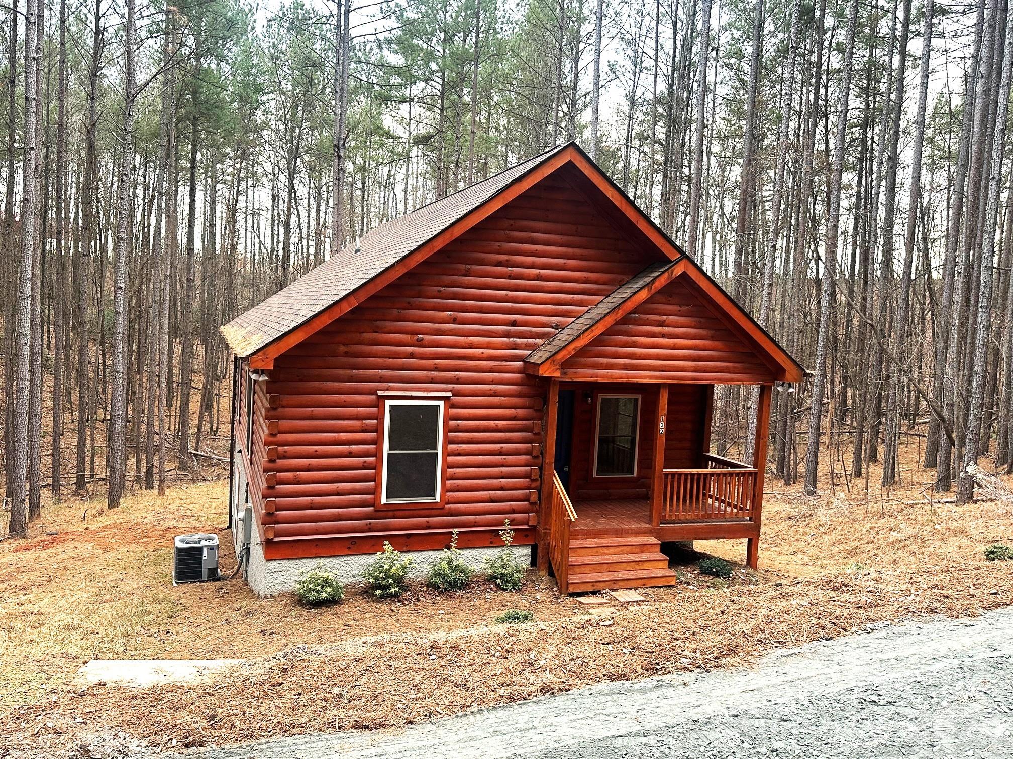 PRICE REDUCED!  New construction Blue Ridge Log Cabin located just outside of Lake Lure.  Location is only about 4 miles from the water's edge of Lake Lure.  Two bedrooms, 2 full baths, kitchen and living room with dining area all on the main level.  The kitchen and both bathrooms have black onyx granite counter tops, and kitchen has all stainless steel appliances.  The stove, microwave, refrigerator and dishwasher are included with the sale of the house.  The living room has a gas log fireplace with stacked stone.  Fuel tank is leased. The full unfinished basement is plumbed for a third bath.  The 3 Bedroom septic permit will allow for future expansion in the basement.  The washer and dryer hookup is located in the basement.  There is an 8 foot wide deck on the back of the house.  Yearly dues is $375.00 for road maintenance.  Vacation rentals allowed.  Convenient to Chimney Rock State Park & many points of interest in Western NC.