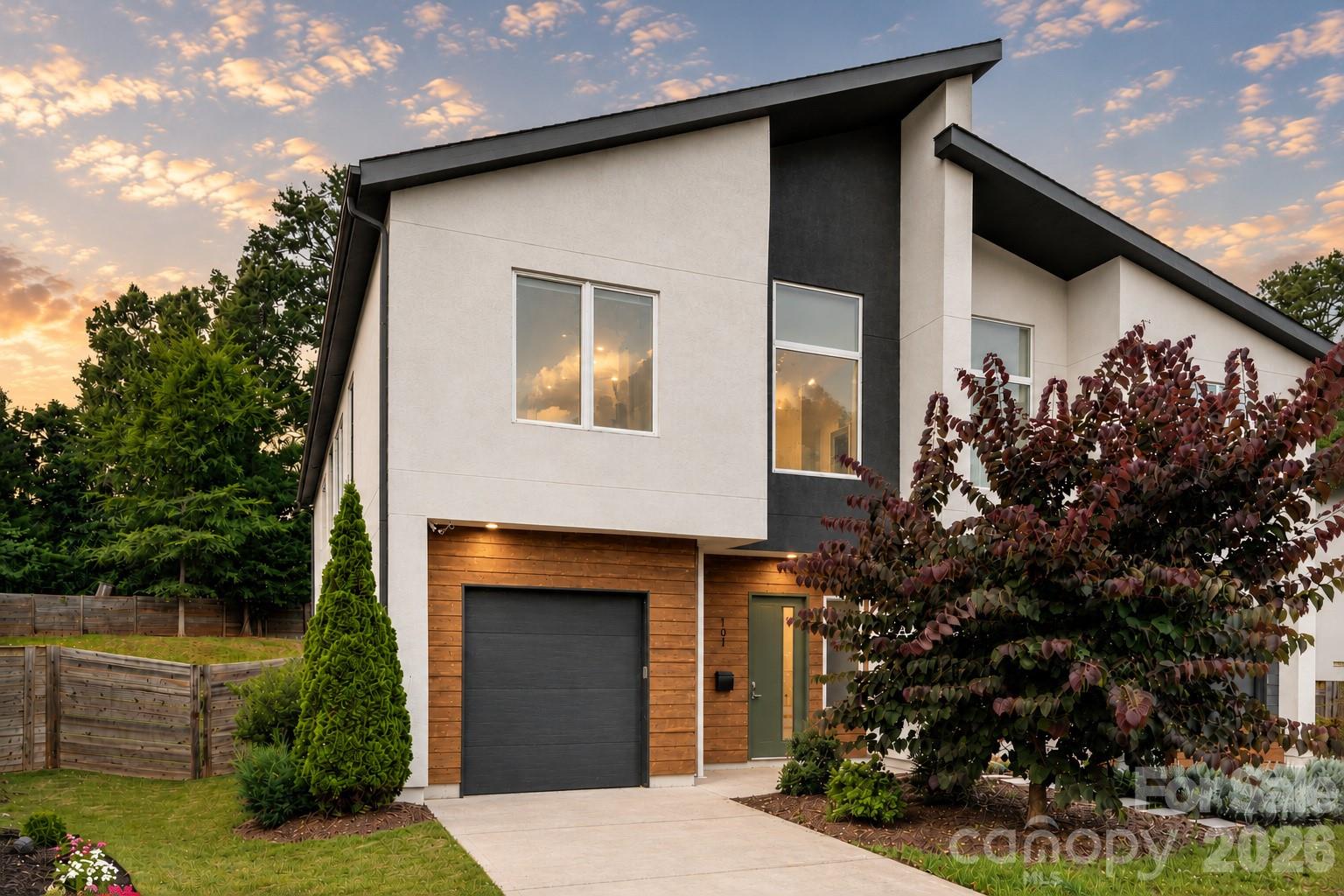 ARCHITECTURE. LIGHT. LOCATION.

Designed for buyers who appreciate clean architecture and elevated design, this striking contemporary residence in City Side West offers a rare opportunity to own one of Charlotte's most distinctive urban homes just minutes from Uptown.

From the moment you step inside, soaring ceilings, oversized windows, and dramatic open spaces create an immediate sense of volume and light rarely found in attached living.

The heart of the home is an exceptional designer kitchen featuring a massive waterfall quartz island, sleek European-inspired cabinetry, gas cooking, double wall ovens, stainless appliances, designer lighting, and abundant storage—all seamlessly connected to spacious dining and living areas anchored by a stunning linear fireplace.

Walls of glass overlook one of the community's larger fenced backyards, offering an uncommon combination of privacy, green space, and low-maintenance living just minutes from the city.

The luxurious primary suite is thoughtfully designed as a true retreat featuring tray ceilings, a private sitting area, an expansive walk-in closet, and a spa-inspired bath complete with floating dual vanities, freestanding soaking tub, oversized walk-in shower, and designer tile selections.

Additional bedrooms each enjoy their own well-appointed bathrooms while flexible living spaces easily accommodate guests, remote work, fitness, or creative pursuits.

Located just minutes from Uptown Charlotte, Camp North End, NoDa, Optimist Hall, South End, Bank of America Stadium, Truist Field, and countless restaurants, breweries, parks, and entertainment venues, this home delivers contemporary architecture without compromising comfort, space, or convenience.

A rare opportunity to own an architecturally inspired home in one of Charlotte's fastest-evolving neighborhoods.