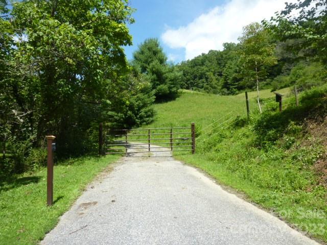 This is an incredible property with long range views, pasture, a spring and wooded areas. There are trails and a tobacco barn that has been converted and repurposed into a sweet and very efficient  barn for 3-4 horses with spring water piped into the barn. This acreage will be cut out of a larger tract with no restrictions other than only stick built or off frame mods are allowed. The drive is already into the beginning of the  property then there is a dirt road that leads to the top of the prop. where there are gorgeous views. That dirt road could be easily widened  and would make a wonderful permanent driveway.  Electric is close by on the property. Just 15 mins to Hot Springs and 55 mins to Asheville or Johnson City. There is an very active community center in this area of Madison County if you want to be involved socially.  We also have a General Store that is 4 miles down the road and folks like to hang out there and see each other like in the ole days of country stores past....