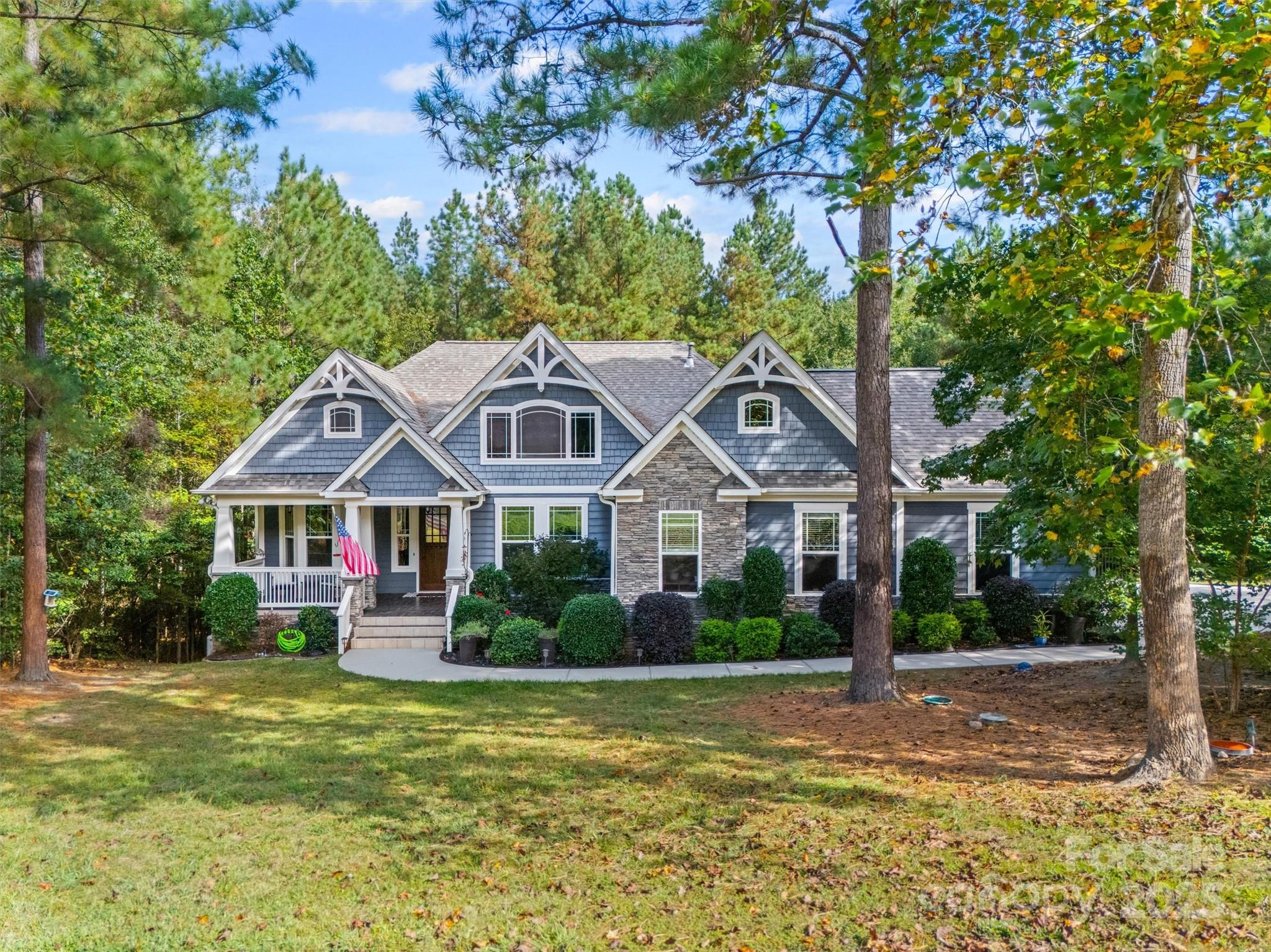 Welcome to Catawba Shores Estates, a premier community along the Catawba River. This 3-bedroom residence offers refined living with the primary suite on the main level, complete with a spa-inspired bath, oversized walk-in shower, and custom closet connecting directly to the spacious laundry room. The main level highlights an open-concept living area with gas fireplace, a light-filled eat-in kitchen with stainless steel appliances, and seamless flow for entertaining. Upstairs, a private bonus suite with full bath and oversized closet provides flexibility for a home office or guest retreat. Outdoor living is equally impressive with a private front porch, screened back porch, expansive deck, and a Michael Phelps hot tub—all set against peaceful, treehouse-like views. Situated on a 1-acre homesite bordering acres of HOA-owned green space, this home offers unmatched privacy. Community amenities include a pool, over 120 acres of preserved land, and scenic trails along the Catawba River, making every day feel like a getaway.