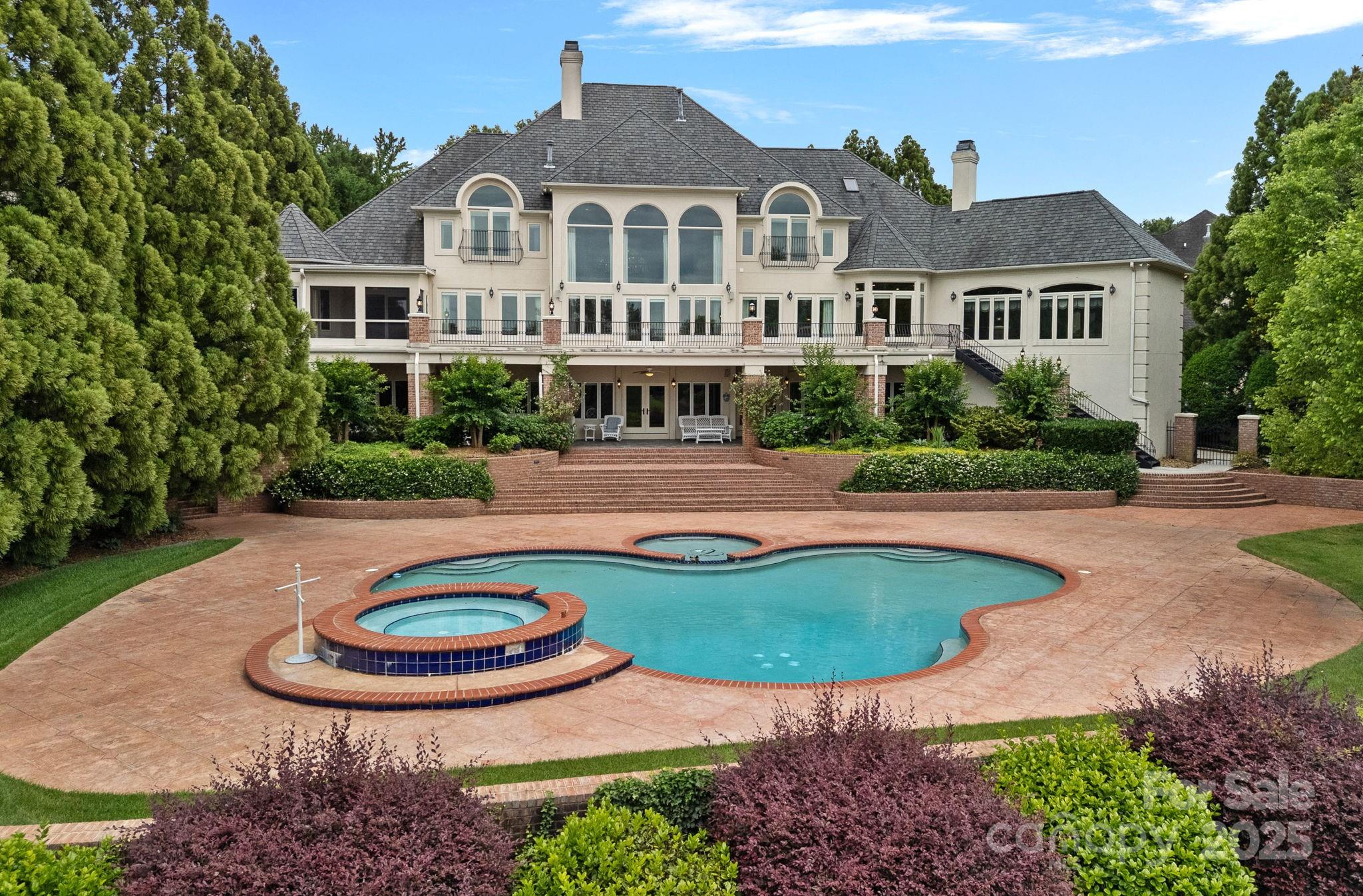 Experience luxury living in Challis Farms, one of South Charlotte’s most exclusive gated communities. This stunning Mediterranean/Tuscan-inspired estate was custom built with exceptional craftsmanship and timeless design. Featuring 5 spacious bedrooms and 6 full bathrooms and 2 half baths, this palatial residence offers both elegance and comfort.  Set on an extremely private lot with beautiful landscaping, the home features a beautifully designed outdoor plaza with an in-ground pool and hot tub, all overlooking a serene, spring-fed lake. Enjoy tranquil, year-round waterfront views from your own secluded retreat—perfect for relaxation or entertaining.  This unique home is an incredible value and in a premier location. Don’t miss the chance to make this one-of-a-kind estate your own.  Priced 20% below pre-listing appraisal for quicker sale.    Do NOT miss out on your chance to live in luxury and walk into instant equity!!   "As-Is" sale.