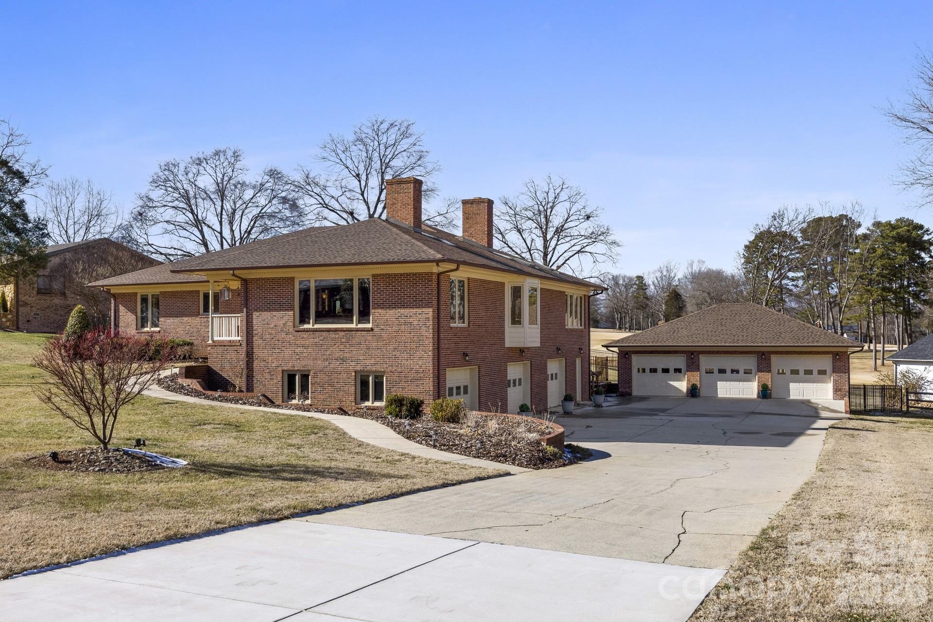 Where panoramic golf course views, luxury living, and a car
enthusiast’s dream garage come together in one unforgettable property. Remodel
completed in 2025, this home sits on the 10th fairway of Pine Island Country Club. Open,
light-filled main level features a vaulted family room with gas fireplace and windows
spanning nearly three sides, flowing into the kitchen. Primary suite offers vaulted ceilings,
remote skylights, and updated bath with rain shower and soaking tub. Includes 3 oversized
attached garage bays plus separate 3-bay garage with new HVAC and three lifts available
for purchase. Finished lower level offers in-law suite with bedroom, living area, kitchenette,
full bath, walk-in closet, and storage. 3 New roofs, 3-ton HVAC, skylights, fireplaces,
flooring, central vacuum, natural gas generator, and Culligan system. Convenient to major
Charlotte corridors, shopping, dining, and commuting.