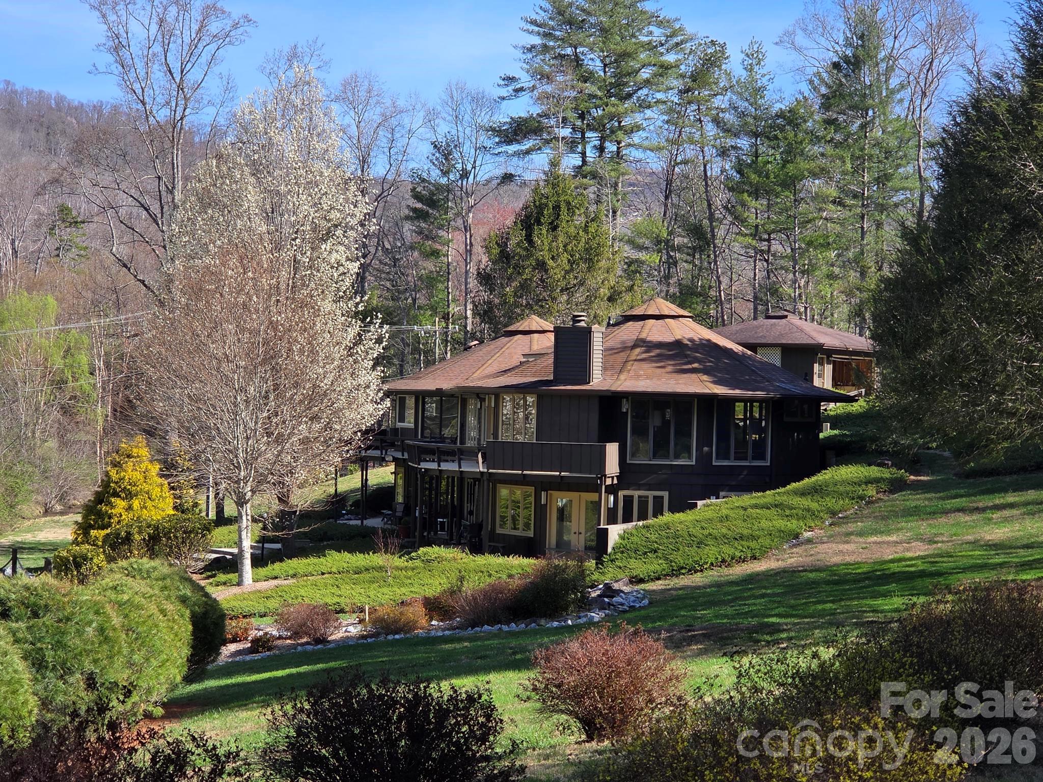 Distinctive double Deltec home featuring a custom-designed connection between the two structures, offering expansive, multifaceted views in a park-like setting on a 3+ acre lot. Featherstone Mill Creek meanders along the rear property line and is a year-round creek, providing a peaceful natural backdrop. The front entry welcomes you with a charming Japanese garden accented by decorative post-and-chain fencing. Many of the rooms are designed for flexible, multipurpose use.
The main (upper) level includes the kitchen, dining area, living room, two guest bedrooms, a full bath, and a half bath. The kitchen offers generous solid-surface counter space, stainless steel appliances, and a pantry, along with ample room for both a sitting area and breakfast nook. Dining area wall are pecky fir. Living room walls are pecky cyprus. Wet bar in LR and fireplace. Skylights in dining area. Upper deck along back of house wraps partially around and has an awning over a portion. Spiral staircase to lower level off deck.
The lower entrance level features a spacious primary suite with split his-and-hers walk-in closets and a well-appointed bath with double sinks, an extra-long vanity, a deep garden tub, and a separate tiled shower. The connecting area provides versatile flex space ideal for a fitness room, study, or recreation area. It has 3 closets for storage. An additional private guest suite with an en-suite bath and a den with a woodstove, utility/mechanical room is partially unfnished and not included in sq ft.
Tons of parking, circle drive on upper level and large parking lot on lower.
This truly one-of-a-kind home has been owned by the same family, along with the surrounding property, for over 200 years.  What a charming possible Airbnb setting.
Please give 24 hour notice for showings.