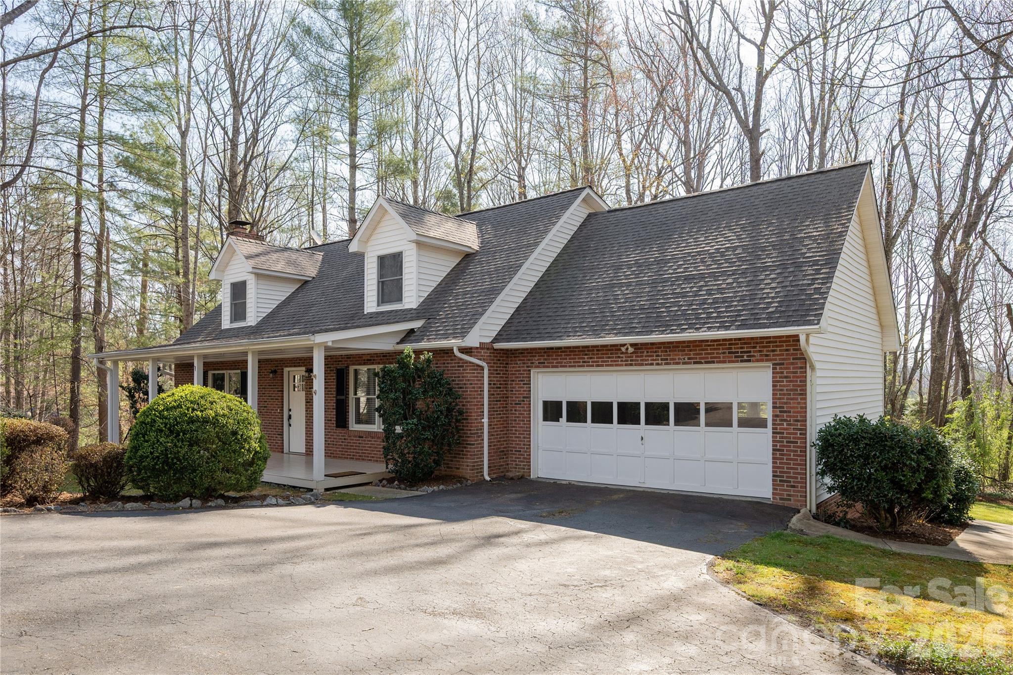 Welcome to wonderful Brooke Hills. This move in ready spacious home flows beautifully with an open concept kitchen, living and dining area anchored by a cozy and attractive gas fireplace. The large sunroom overlooking the expansive backyard area provides additional functional space, perfect for hobbies, exercise or additional living space. The main level primary bedroom and large laundry/mudroom provides added convenience. The upstairs space with two bedrooms and a full bathroom also has a great office space that could be reimagined for multiple uses. The large lot provides plenty of space for garden or play with wooded areas, green areas and beautiful mature landscaping. A small fenced area below the rear deck provides a great and secure area for your furry friends. A large driveway along with a two car main level garage lends itself to easy entering/exiting of the home. The location provides ease of travel to Hendersonville, Brevard and the Asheville Airport and is within walking distance to the Etowah Valley Golf Course. This fantastic property offers it all! Come take a look today. Per Henderson County GIS records this property may attend Mills River or Etowah Elementary schools.