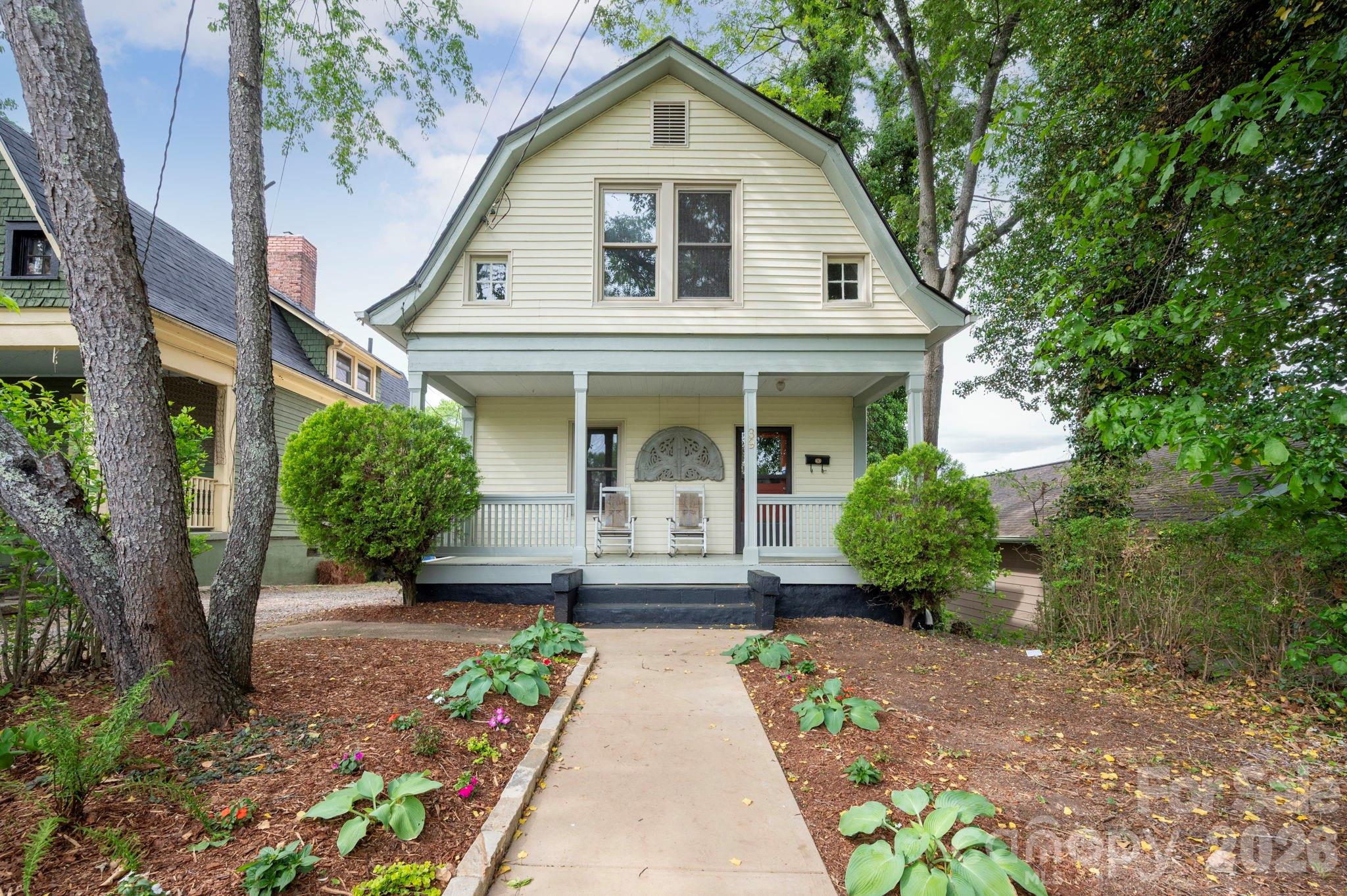 Central Asheville. 1910 Foursquare. Downtown Views.

Built around 1910 and well maintained, this two-bedroom, two-bath home sits in a prime south central Asheville location with easy access to downtown, the River Arts District, and Biltmore Village. The Jackson Building is visible from the backyard and bedroom.

Wood floors run throughout. The kitchen has been updated with quality finishes and appliances. Both full bathrooms are in good condition. The layout is straightforward and functional with good natural light.

The covered front porch runs the width of the home and is a genuine asset. A walk-out basement provides substantial storage, which is uncommon for a home of this age and size in Asheville.

The yard is landscaped with established plantings and a stone-edged front walkway. The gambrel roofline and original lap siding give the home strong street presence. A property worth seeing in person.