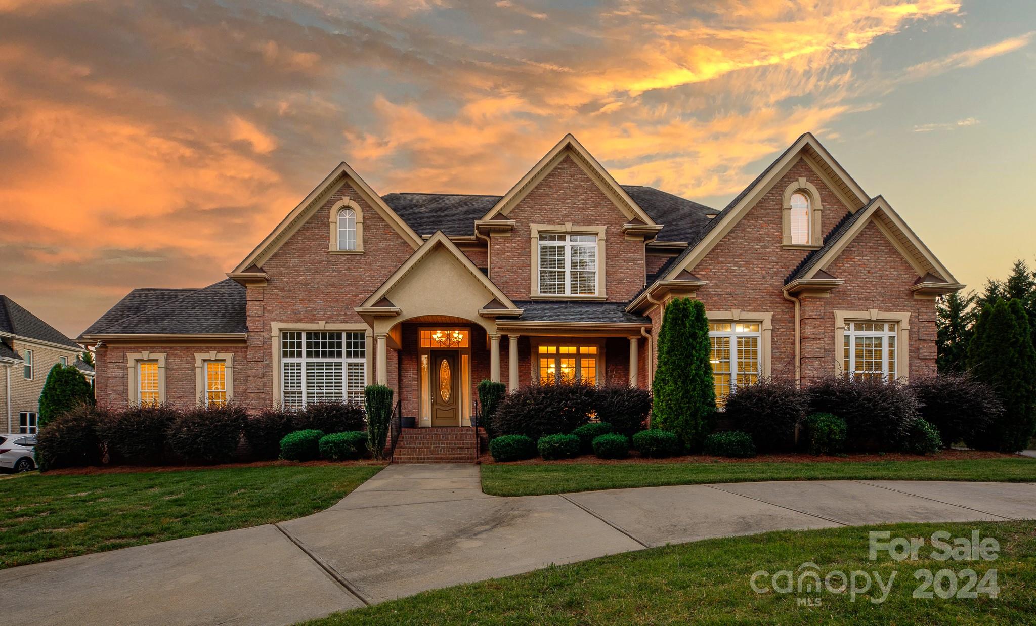 Tucked in the prestigious Laurel Creek subdivision, this exquisite home blends luxury & elegance with modern comfort. Offering 5 bedrooms & 5 bathrooms, the home’s design is as functional as it is beautiful. Gleaming hardwood floors lead you through the open floor plan, where the gourmet kitchen impresses with quartz countertops, an oversized work island, walk-in pantry & a butler’s pantry. Soaring ceilings enhance the grand living spaces, including a formal dining room, office & sunroom. The primary suite & an additional bedroom are conveniently located on the main level, with the primary suite featuring a relaxing sitting area, dual walk-in closets & a spa-like bath with an expansive double shower. Upstairs, a bonus room with a wet bar provides the perfect spot for relaxing. The circular driveway & oversized side-load 2-car garage offer plenty of parking. All of this is located in a community known for its exclusive amenities, including a pool, tennis courts & scenic trails.