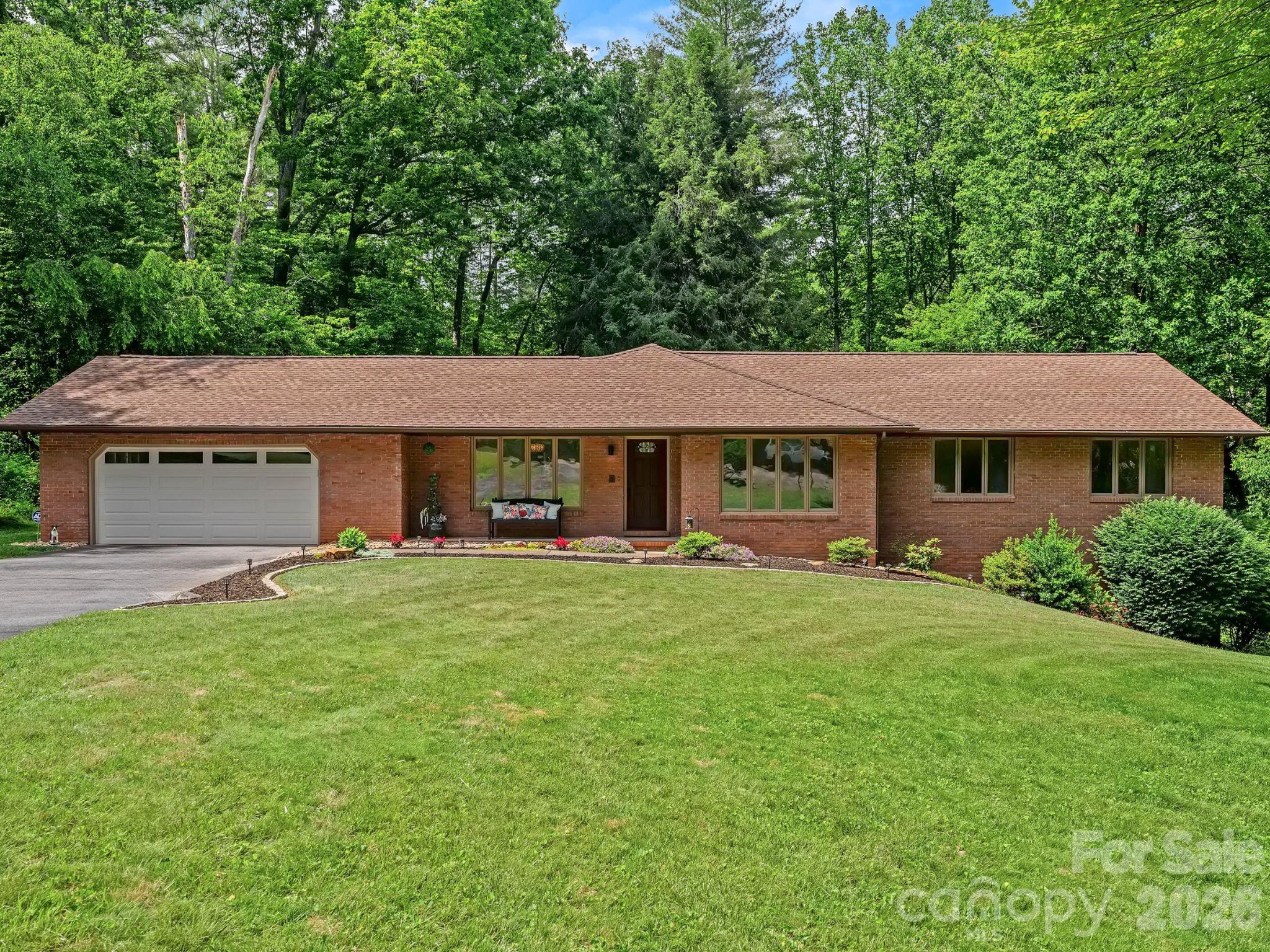 Tucked into the sought-after luxury community of Challedon, this timeless brick rancher welcomes you with the kind of peace and permanence that only an established neighborhood can offer. Set at the end of a quiet cul-de-sac amid mature landscaping, the home offers a rare sense of seclusion without sacrificing convenience.

Offering more than 4,000 square feet of living space, the thoughtfully designed floor plan is highlighted by an exceptional lower level that dramatically expands the home's possibilities. Complete with a second kitchen, full bathroom, expansive living area with fireplace, and two versatile bonus rooms, the space is ideally suited for multi-generational living, extended guest accommodations, recreation, creative pursuits, or the flexibility today's lifestyles often require.

Expansive windows throughout the main level fill the home with natural light and frame views of the surrounding landscape. A spacious living room centered around a fireplace invites quiet evenings and meaningful gatherings, while the formal dining room and bright kitchen with breakfast area create inviting spaces to linger over meals and conversation. The primary suite offers a peaceful retreat with direct access to the expansive rear deck, where mature trees provide a beautiful backdrop throughout the seasons.

Blending enduring craftsmanship with remarkable versatility, this is a home designed to evolve alongside every stage of life.