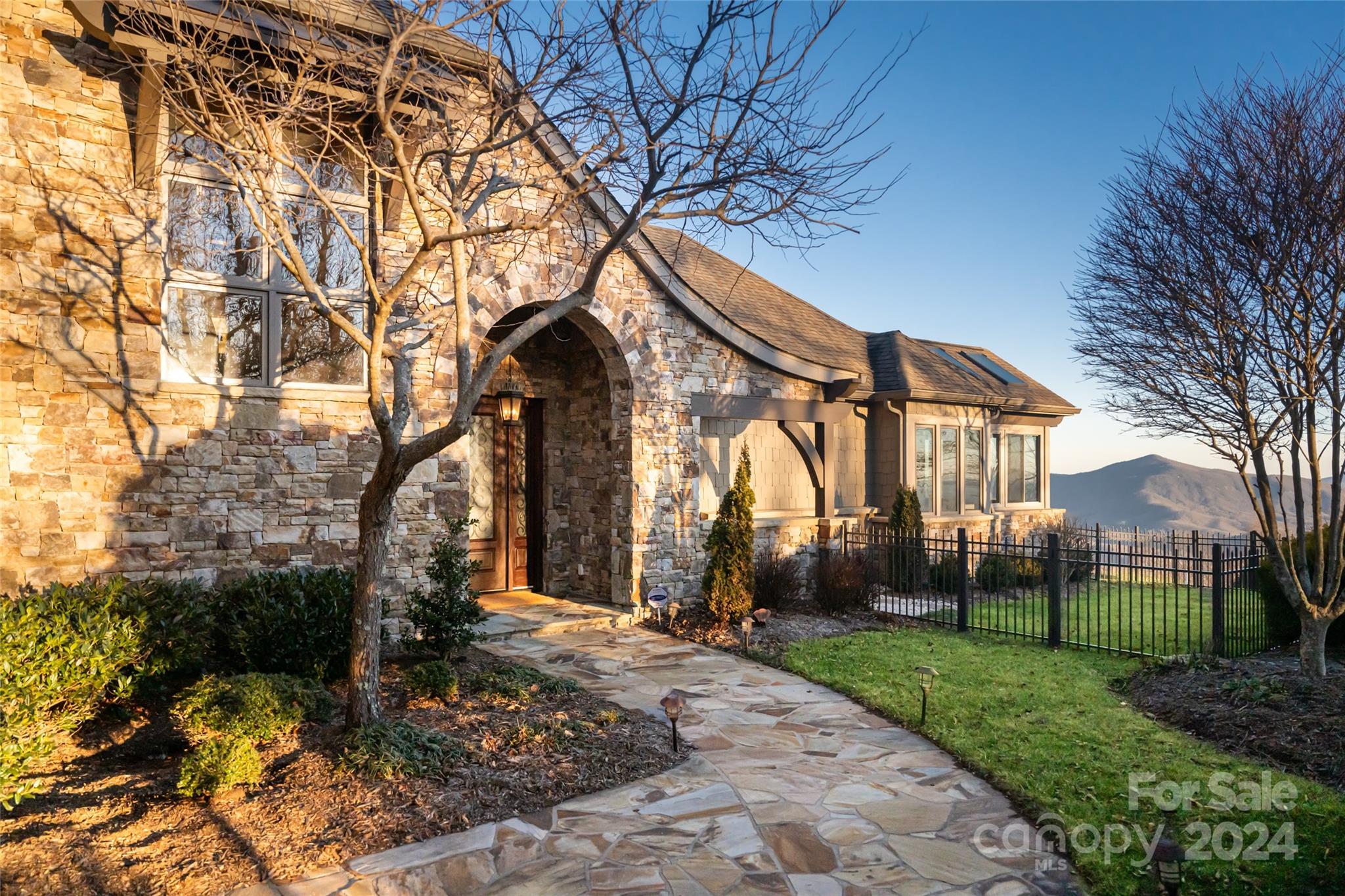 Hickory Forest is a custom built, 5 bed, 5+ bath mountaintop oasis on 24.5 acres at nearly 4,000 ft affording cooler summers. The interiors showcase incredible depth and natural light throughout a thoughtful and open floorplan. White oak floors, 10' coffered celings and a statement stone fireplace highlight the living room. The kitchen includes a large island, 36” Wolf range, custom cabinetry, and walk-in pantry. Enjoy a 4-seasons room with  fireplace and elevated deck just off the dining room. The main level primary suite features double vanities, walk-in shower, jacuzzi tub, a deck, and 4-seasons room. The 2nd level includes a family room with wet bar and full bath, two guest bedrooms and full bath. On the terrace level a recreation room with gas fireplace leads to 2 en-suite bedrooms, home office, large gym, and enclosed heated pool with retractable roof. Additional features: 3 car garage, geothermal HVAC system, solar array, 2 wells, and LEED Platinum Certified Home 5-Star Rating.