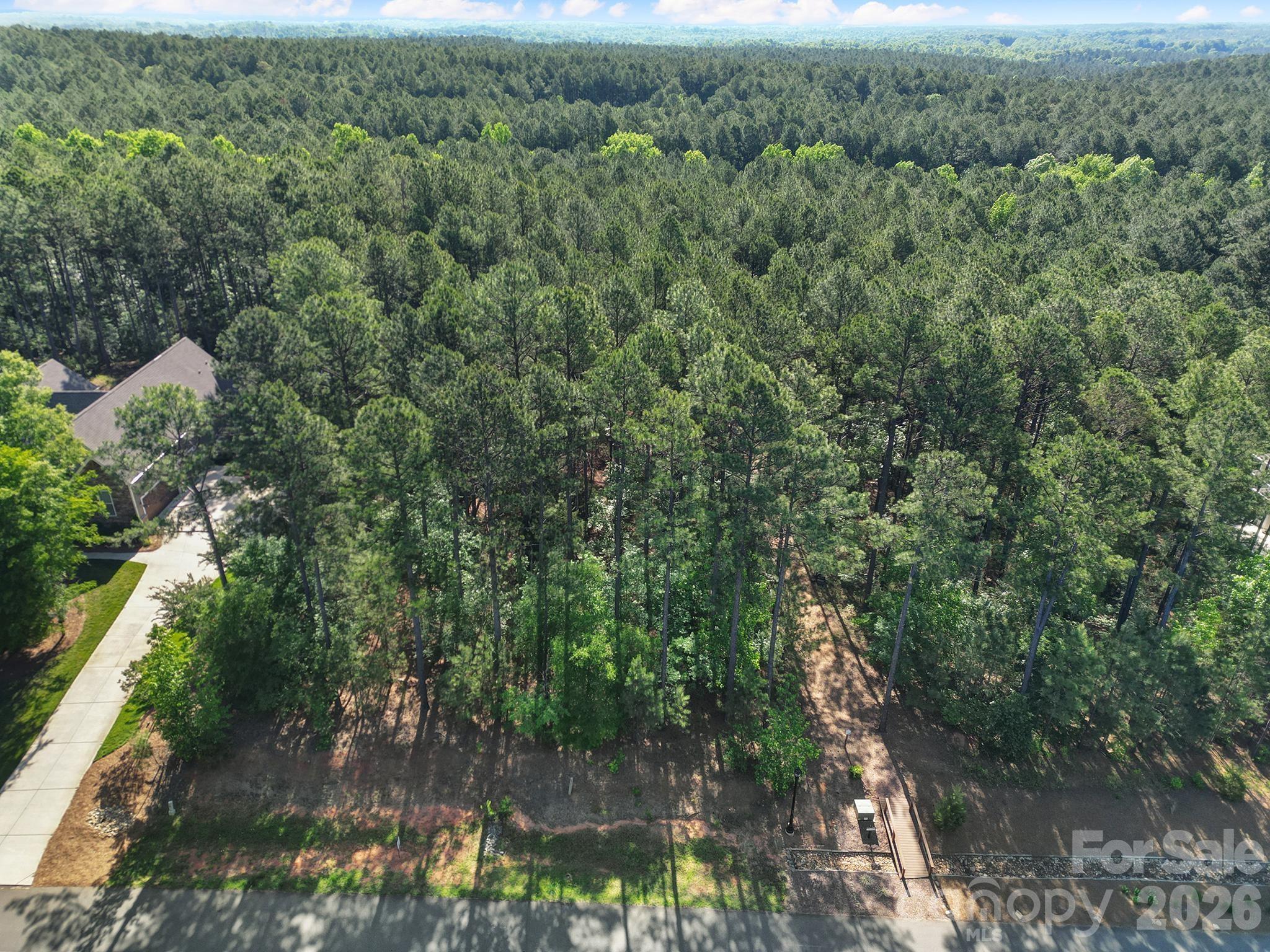 Build your next home in Riverchase Estates, where the neighborhood amenities are just as impressive as the homes going up around them. This 1 acre lot sits in Phase 1 with direct access near the trailhead leading into a 500-acre nature preserve—perfect for hiking, biking, or just getting outside without leaving the community. Riverchase is packed with amenities including a lakeside park, resort-style pool with lap lanes, clubhouse, fitness center, playground, basketball and tennis courts, amphitheater, and Riverside Landing for kayaking and canoeing on the Catawba River. Gated entrance adds extra privacy, while the location keeps you close to I-77 and Hwy 521 with easy access to Fort Mill, Indian Land, Charlotte, shopping, dining, and entertainment. Bring your own builder and create something that fits your lifestyle from the ground up. *Property cannot be sold to an AgSouth farm credit employee or relative of employee. Property is bank owned and a limited warranty deed will be offered at time of closing.