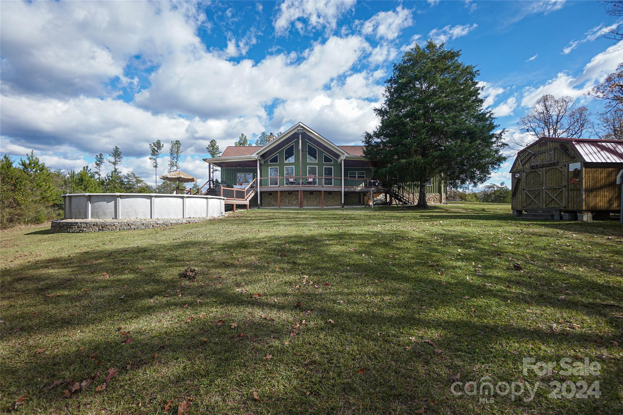 40+/- acres with a custom built 2 BR house & office on an absolutely stunning property teaming with wildlife. This is an immaculate custom built rural home with a fresh water pool, seclusion, a year round creek, outstanding hunting, multiple barns, and a new 74 x 24 metal storage building for your boats, tractors, mowers, ATV's and outdoor toys. It also has a separate covered RV metal barn/shed with extra storage for even the largest RV's. Located a few minutes from Lancaster, Great Falls and the new Great Falls Whitewater Park and is roughly an hour from Charlotte or Columbia and about 20 minutes from Lake Wateree. This home was built to exacting standards with 9 foot ceilings, 2 x 6 exterior walls, renovated bathrooms, R-19 insulation with great attention to detail. You will love the 800 +/- feet of exterior composite decking and long range views reminiscent of the mountains. The property is surrounded by large timber tracts for seclusion and Camp Creek as a western border.