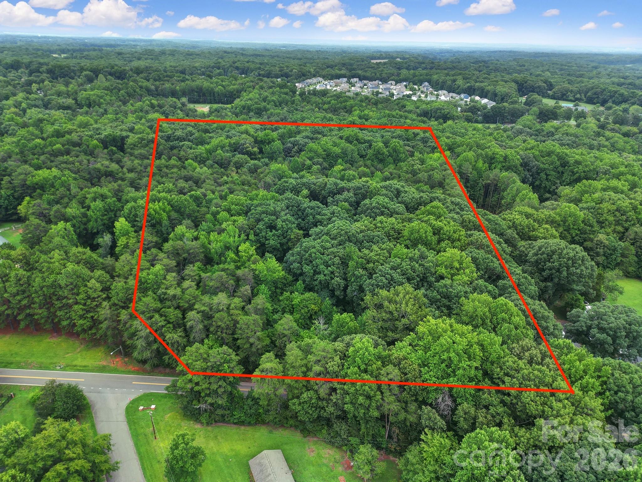 A rare ±9.28-acre offering in the heart of Mint Hill, with approximately 379 feet of frontage along Williams Road and a blank canvas for new construction. Set in one of Mecklenburg County's most sought-after small towns, the property pairs the privacy and elbow room of acreage with quick access to downtown Mint Hill and a short drive into Charlotte.

Zoned R (Residential) within the Town of Mint Hill, the land allows single-family residential use by right. It's an ideal setting to build a private estate home or to explore the parcel's highest and best use.

Nearly ten acres of residentially zoned land, with real road frontage and no floodplain designation, is increasingly hard to find in the Charlotte metro. Whether you're a builder, a developer, or a buyer seeking room to create something special, 10720 Williams Road rewards a closer look.

Prospective buyers are encouraged to verify utility availability (water/sewer), confirm zoning and development options with the Town of Mint Hill, and conduct their own due diligence. Survey and additional materials available upon request.