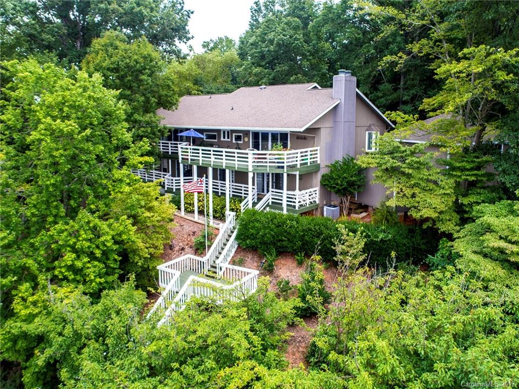 Welcome home to this million-dollar waterfront view from the southwestern-most residence in Tega Cay! Enjoy main channel, yr. round sunsets from dock, gazebo, 2 -60' decks & most every room in home! Meticulously clean w/fabulous kitchen, Lg. Br's, master w/ updated bath & 2 walk in closets. Home originally 4 BR-easily converted back. HW floors; formal dining, Lg. breakfast area. Marble & stone FP's- 1 gas/1 wood-burn. Garage currently used as shop. Great storage w/room to grow!