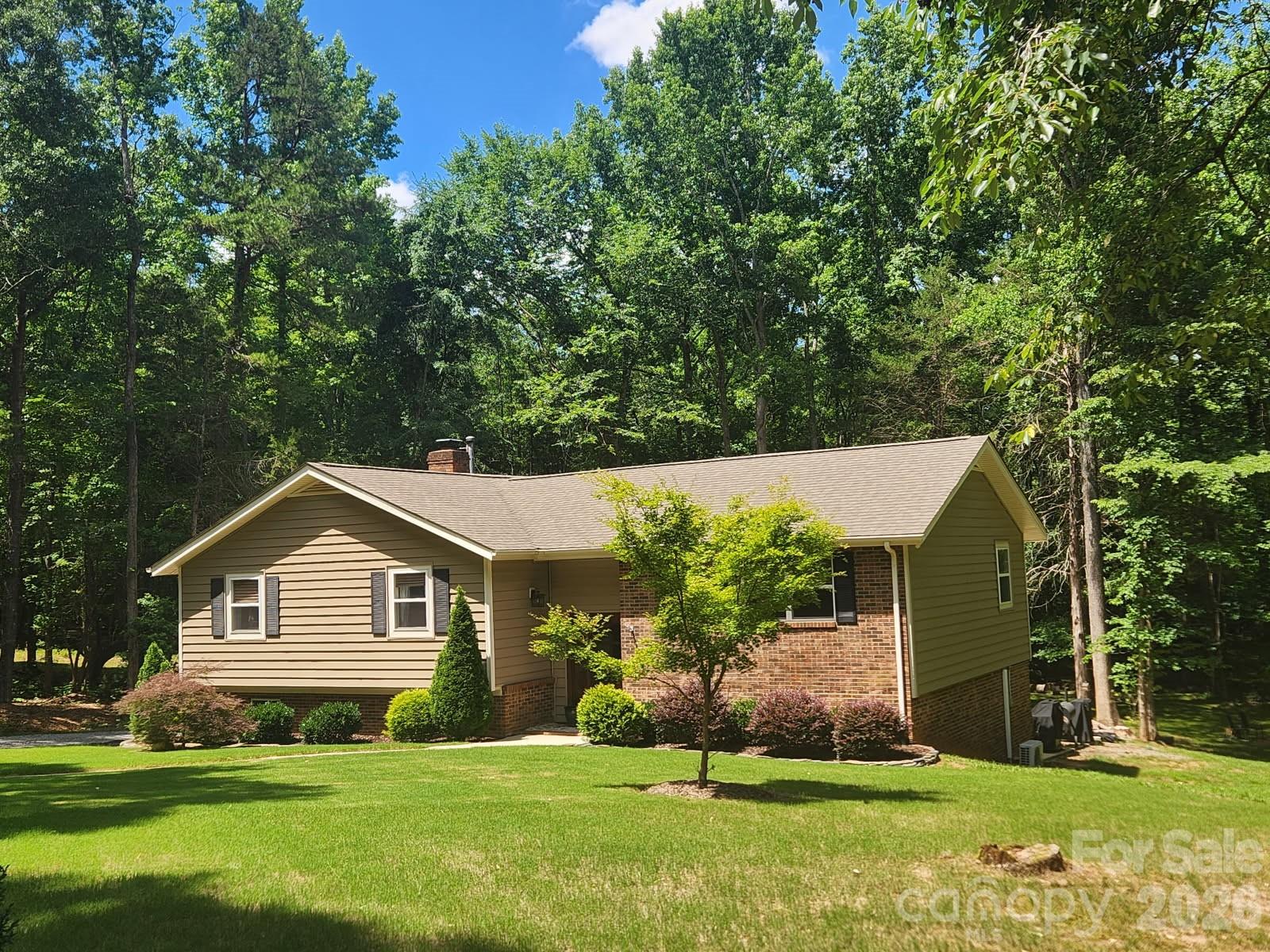 Discover the perfect blend of privacy, space, and convenience in this beautiful 4-bedroom, 3-bath home nestled on a tranquil cul-de-sac lot in an established equestrian community in Indian Land, SC. Situated on 2.82 wooded acres, this property offers a serene retreat while remaining just minutes from dining, shopping, and the Ballantyne area.

The split-foyer floor plan provides flexible living spaces and comfortable everyday living. The kitchen features granite countertops, a gas stove, and easy access to the dining area, making it ideal for both entertaining and family gatherings. All appliances convey, including the washer and dryer, allowing for a seamless move-in experience.

The finished lower level expands the living space with a cozy fireplace, a versatile workshop/art studio, and walk-out access to the outdoors. Whether you're pursuing creative projects, working from home, or seeking additional recreational space, this level offers endless possibilities.

Enjoy the amenities of this sought-after equestrian neighborhood, including a community pond, pool, clubhouse, and boarding facilities for horse enthusiasts. Surrounded by nature and offering exceptional privacy, this property is a rare opportunity to enjoy peace and tranquility without sacrificing convenience.