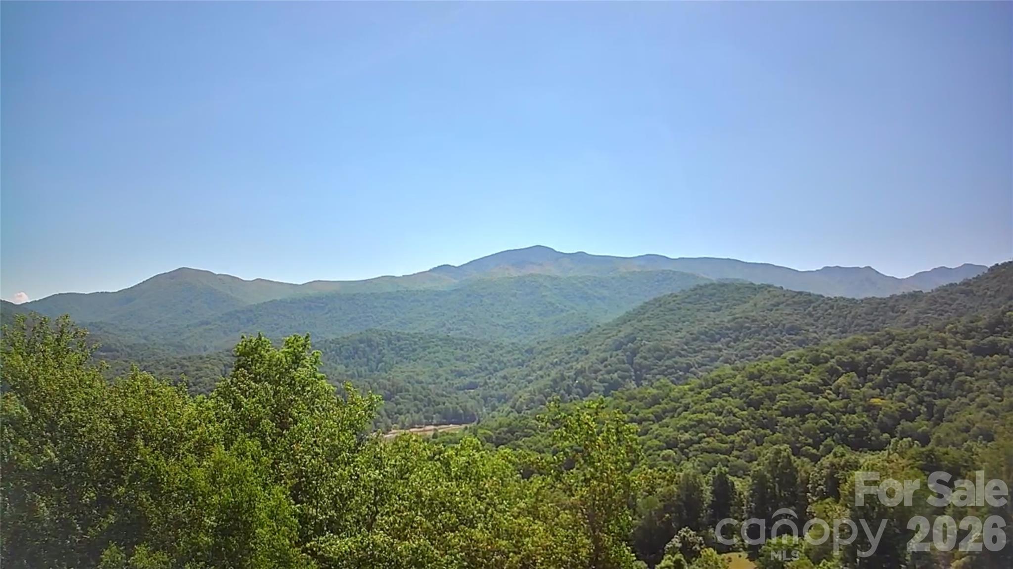 This mountain gem truly has it all — stunning long-range mountain views, gentle buildable land, peaceful surroundings, and an ideal location just minutes from town. Four adjoining lots are being offered together as one remarkable property, located just 15 minutes (7 miles) from the charming town of Burnsville.

Situated at over 3,000 feet in elevation, this beautiful mountain property features mostly level to gently sloping terrain with desirable southern exposure and the potential for breathtaking long-range views of Celo Knob and the Black Mountains. Convenient access from two well-maintained private roads provides both flexibility for building and added privacy within a peaceful mountain community.

A seasonal spring flows through the property, adding to its natural beauty and creating the potential for a unique landscape feature. Ideally located near the Cane River, this property is perfectly suited for a private mountain retreat, vacation getaway, or full-time residence with easy access, serene surroundings, and inspiring year-round mountain views.