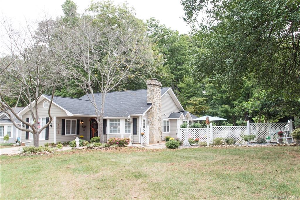 Lush home with lots of bells and whistles! Hand-scraped wood floors throughout home, tile in baths, unique features around every corner. Vaulted GR with gas logs, huge MB with sitting area, jacuzzi bath tub with double shower heads, surround sound throughout home, bird viewing in the sunroom with gas log furnace, quiet back deck, lovely fenced courtyard with stone features, low e coating argon windows, Hunter ceiling fans in all beds, living room and kitchen, programmable door lock and doorbell!
