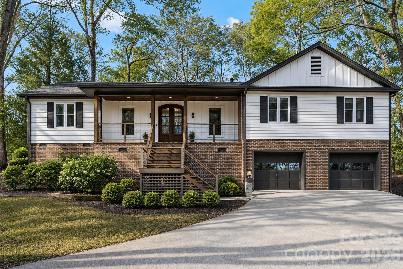 "Come home to a resort every day."  That's the motto for one of Lake Wylie's most sought-after waterfront communities, River Hills. And this beautiful full reno positioned within the community offers the perfect blend of updated design, comfort, and lifestyle. Step up to the welcoming front porch and through the wood double doors into a bright & open living space with vaulted wood beamed ceiling.  The kitchen serves as the heart of the home, featuring seamless quartz countertops & backsplash, waterfall island, stainless appliances with dual ovens, abundant storage, and a charming coffee bar niche perfect for your morning routine.
The large primary suite offers an accent wall, designer wallpaper, and a boutique style with floor-to-ceiling glass-front cabinetry.  The spa-inspired bath features an oversized walk-in shower, soaking tub, illuminated LED mirrors, and sleek modern cabinetry. 3 additional bedrooms on opposite side of the home offer flexibility for family, guests, or remote work. The lower level includes a spacious laundry room with cabinetry and utility sink, while the oversized two-car garage provides ample storage and workspace. Major infrastructure improvements include vapor barrier and insulation in the crawl, all new windows, roof & gutters 2024.  Beyond the home, enjoy all that River Hills has to offer: 24-hour gated security, a private country club, championship golf, marina, waterfront park, walking trails, tennis and pickleball courts, swimming pools, and a vibrant calendar of community events. This isn't just a home—it's a lifestyle.