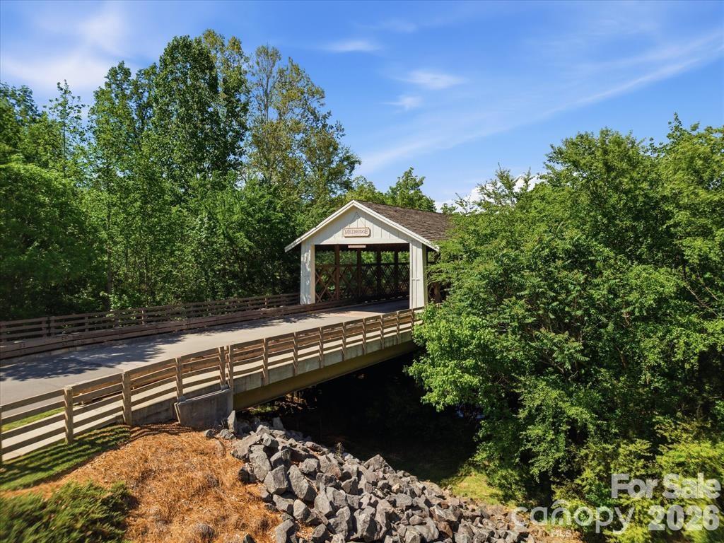 Beautifully maintained one-owner home on a premium wooded lot in a sought-after resort-style community. Built in 2019, this 4BR/3BA home with bonus room offers over 3,200 sq ft of well-designed living space. The kitchen features a large island, double wall ovens, granite countertops, subway tile backsplash, soft-close cabinetry, butler’s pantry, and a custom walk-in pantry, all opening seamlessly to the main living area with gas fireplace and abundant natural light. Upstairs, the spacious primary suite includes tray ceilings, a sitting area with custom built-ins, and a spa-like bath with tile shower, soaking tub, dual vanities, and walk-in closet. A versatile loft provides flexible use, with potential for a fifth bedroom. Additional features include LVP flooring, crown molding, covered porch, extended patio, and added storage. Enjoy community amenities including pools, recreation areas, and more, with convenient access to shopping, dining, and nearby Waxhaw. Assumable loan available—contact agent for details. Lender credit with prefer lender Home Simply.