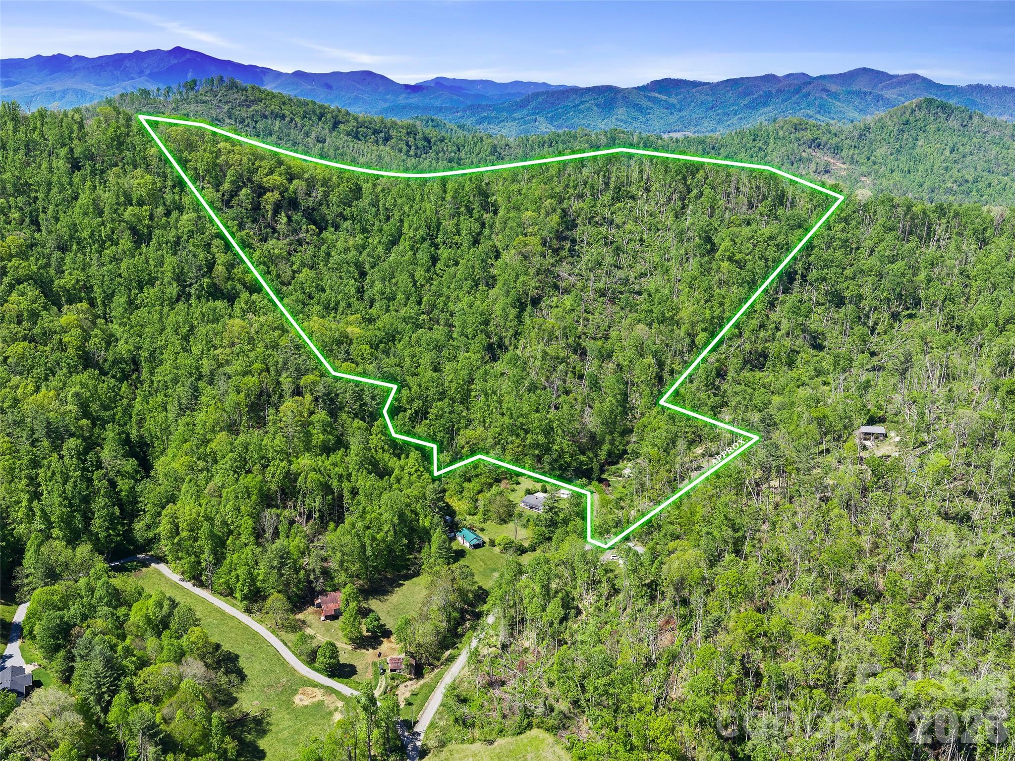 Tucked just off  White Oak Road in Bakersville, this property offers 20+ acres of gently rolling to sloping mountain land with  long-range views that expand the higher you go. Whether you’re dreaming of a private mountain retreat  or a small homestead, this tract gives you room to spread out and truly create something special.

At the heart of the property sits a classic farmhouse—a sweet reminder of days gone by. She did take a hit during Hurricane Helene when a tree came down, but for the right buyer, she could be a charming fixer-upper with a comeback story.

If you’ve been waiting for land that offers story, setting, and serious potential, 615 Fred Sparks Road is ready for its next chapter. Come walk the property, dream a little higher, and see how this Bakersville acreage can become your own mountain legacy.