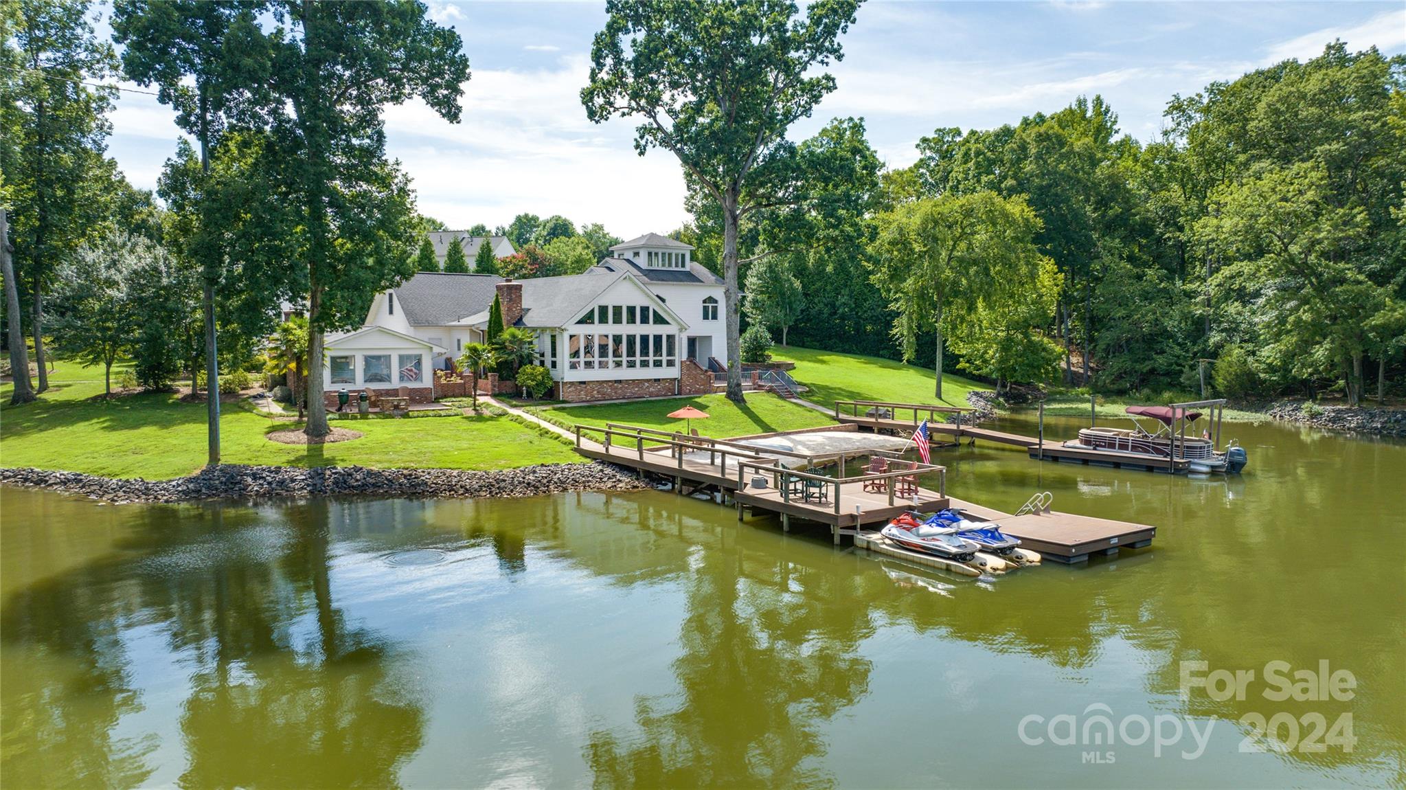 **Showings begin August 15th** One of the rare homes at Lake Wylie to be allowed two docks (grandfathered in) and its own personal sandy beach. This home sits on 1.331 acres with NO HOA and features a gated entry, pool house with kitchen, garage space for more than 5 large cars with workshop, living space w/ full bath above it, and a saltwater cocktail pool for easy lounging with cool deck coating just added. Other notable features include, Hague Complete Water Treatment System (2021) , encapsulated and dehumidified crawlspace, rebuilt docks with low maintenance materials and commercial level drainage systems around the entire property. See the low maintenance costs, survey and a report verifying the home is NOT in a flood zone and flood insurance is not required in the attachments. This is a great opportunity. Sellers have taken great care to do things right as they had no intention of leaving this home, they just want to leave in order to be closer to the grandkids.