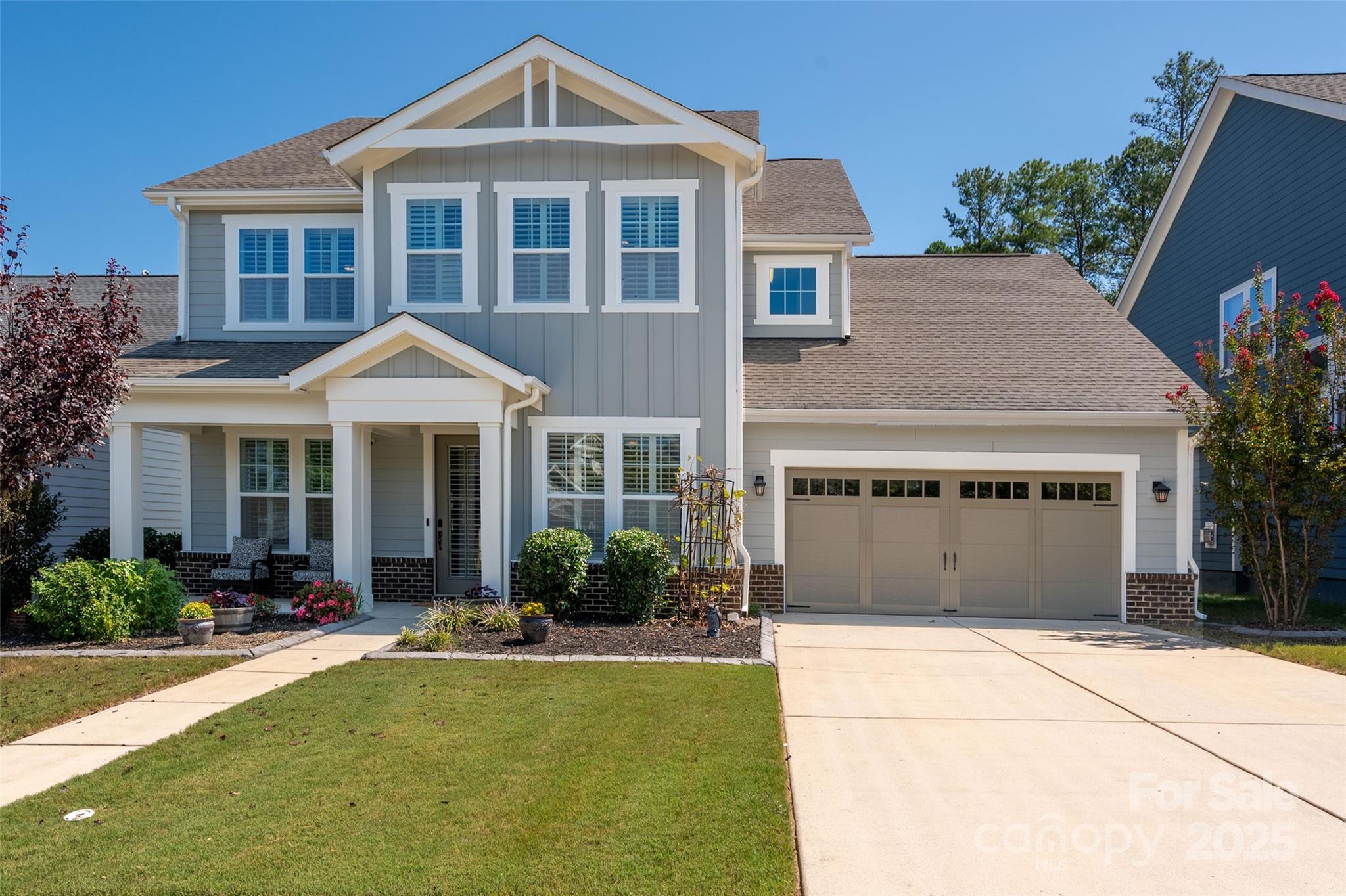 NEW PRICE +  $10,000 Seller Credit provided to Buyer!   Located in the highly desired Paddlers Cove, this 5 Bedroom / 4.5 Bath home is designed with today’s lifestyle in mind. A sought-after home office and a main-floor guest suite provide the perfect balance of work, comfort, and flexibility — ideal for remote work, visiting guests, or multigenerational living.   The chef’s kitchen is a standout, featuring stainless steel appliances, a gas range, walk-in pantry, and abundant counter space — perfect for everyday meals or entertaining.   The main level also offers gorgeous hardwoods, a formal dining room, a powder room, and a bright breakfast area. Upstairs, the elegant primary suite includes a spacious bedroom, dual walk-in closets, a large tiled shower, and a soaking tub. Three additional bedrooms — each with walk-in closets — plus a versatile loft provides plenty of room for family or guests.   Outdoor living is equally inviting. Relax on the extended screened-in patio, complete with a stone fireplace, and enjoy the privacy of a fenced yard that backs to a wooded natural area.   Additional highlights include a freshly painted exterior and an extended garage with custom storage rack for ample storage.    Living in Paddlers Cove means resort-style amenities at your doorstep: two community pools, parks, walking trails, and close access to Lake Wylie.   Don't miss this beautiful home!