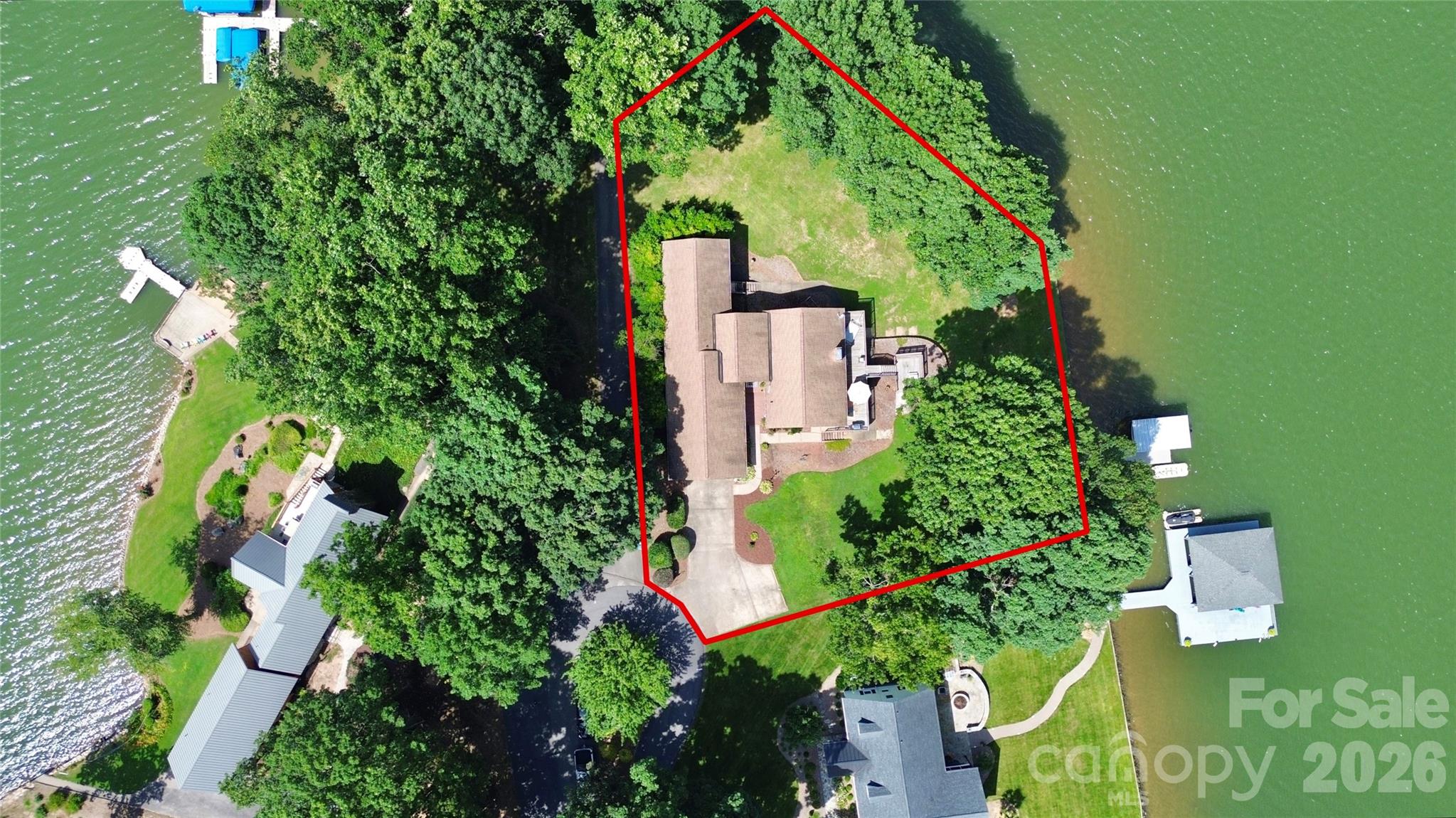 Waterfront on Moss Lake! Stunning home with year-round million-dollar views! This well-maintained 3-bedroom, 2-bath property is full of charm inside and out. Inside, enjoy lake views from every bedroom, a sunroom with a hot tub, and a gas log fireplace in the living room that connects seamlessly to the kitchen and dining area. The spacious primary suite opens directly to the back deck overlooking the lake. The finished basement includes a woodburning fireplace and offers both indoor accessibility and walk-out access to the lake. Outside features a private pier with a covered boat slip and lift, approximately 200 feet of lake frontage, a multi-tiered back deck for entertaining, and an existing invisible fence for pets. Truly a home that makes you feel like you are on vacation while sitting on your own couch or while fishing from your backyard! Additional features include a 2-car garage and a separate upper parking area. Additional 403 SQFT is finished basement not accessible through HLA