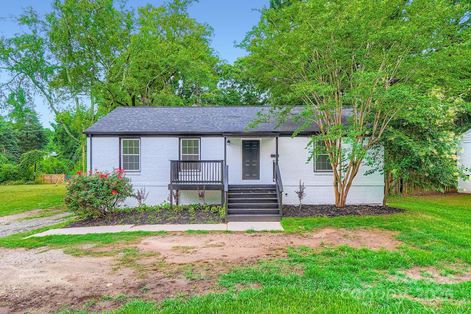 Renovated Brick Beauty in the Heart of Madison Park! From the moment you arrive, this updated painted-brick home makes a statement — and the inside delivers on every promise. Thoughtfully renovated from top to bottom, this 3-bedroom, 3-bath home with a fully finished lower level offers the kind of space, style, and flexibility that's nearly impossible to find at this price point in one of Charlotte's most established and sought-after neighborhoods.
Step inside to an open, airy living and dining area bathed in natural light, where fresh neutral tones, crown molding, and warm laminate wood floors set the tone for the entire home. The layout flows effortlessly — perfect for everyday living and easy entertaining.
The updated kitchen features crisp white shaker cabinetry, sleek quartz countertops, a bold black-and-white mosaic tile backsplash, and a matte black faucet — a clean, on-trend look that feels fresh and intentional.
The oversized primary suite is a true standout — spacious enough to easily accommodate a king-size bed plus a sitting area, with multiple windows framing views of the mature trees beyond. The en suite bath is beautifully appointed with a marble-look tiled walk-in shower, white vanity, and matte black fixtures throughout. A second main-level bedroom offers flexibility for guests, family, or a dedicated home office, served by a fully updated hall bath.
Downstairs, the finished lower level is where this home truly separates itself from the competition. A sprawling recreation room with recessed lighting and a separate kitchenette creates the ultimate flex space — think game room, media lounge, or guest suite. A generously sized third bedroom with a double-door closet and a full bath with a glass-enclosed shower and large-format tile complete the lower level. Whether you need multigenerational living or simply room to spread out, this space delivers.
Outside, the covered rear patio is ready for summer evenings, and the large, flat backyard — framed by lush mature trees — offers real potential for outdoor living. A storage building and long driveway add everyday practicality.
Additional highlights include replacement windows throughout, a new HVAC system, and an unbeatable location just blocks from Park Road Shopping Center, with easy access to South End, Uptown Charlotte, and the Greenway trail system.
Please note: The left portion of the lot falls within a high-risk flood zone. Buyers should consult their insurance provider to determine if flood insurance will be required.