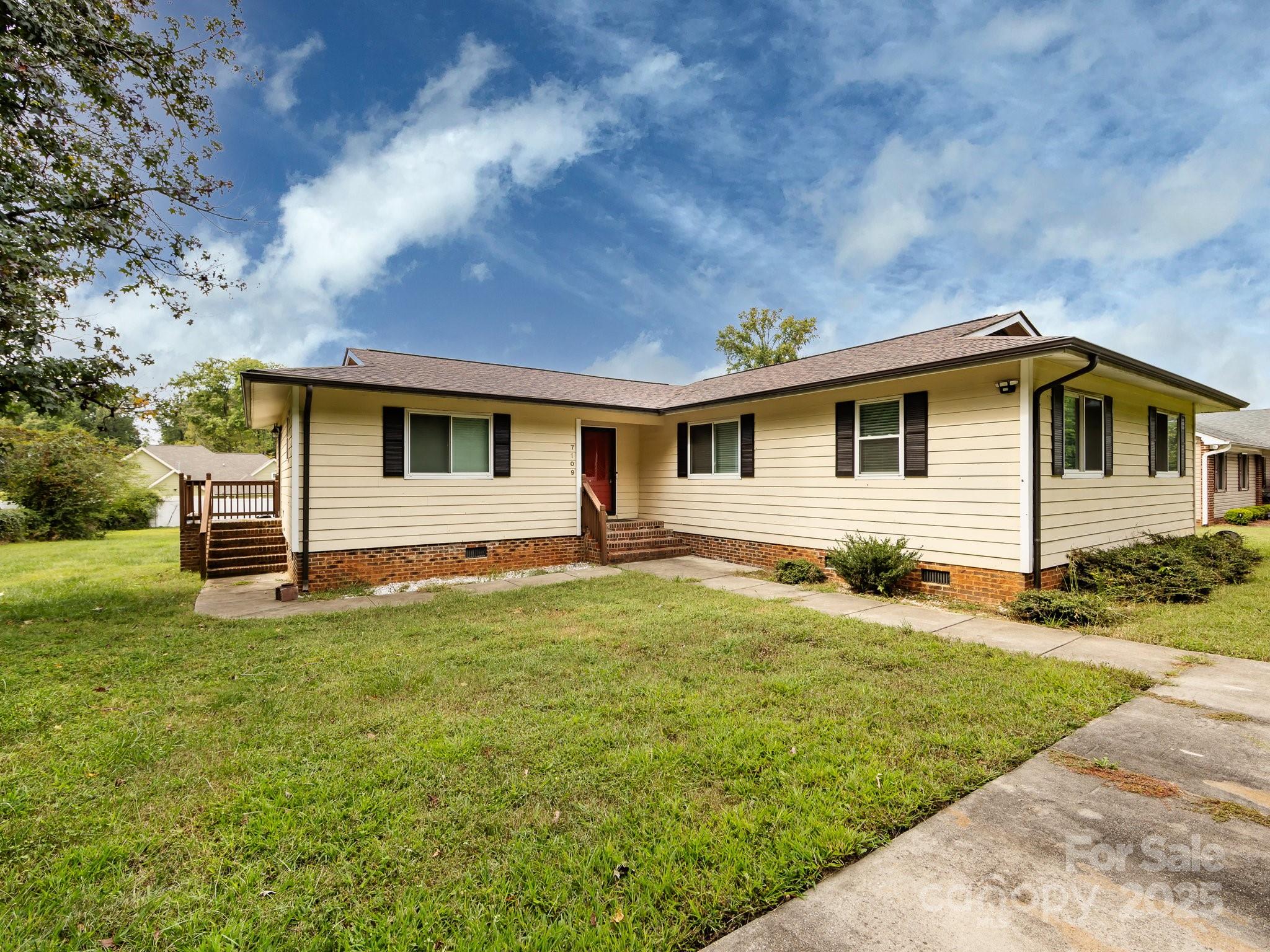Back on the market, no fault of the seller. Looking for a no HOA community w/ a BIG level backyard w/ a 2 tier deck measuring 24 x14 ft. on the upper/main deck & approx. 9 x 7.5 on the lower deck for great entertaining. There is a 12 x 10 ft. storage building that is wired w/ electrical. Inside the home has a  great room(approx. 19 x15 ft.) & dining area(16 x 11ft.) w/ laminate wood flooring. Updated kitchen has large tile floor, island w/ built-in wine cooler, large subway tile back splash, and pass through opening to the dining area w/ a ledge to add barstools if desired. Kitchen includes refrigerator but also has space for a freezer or 2nd refrigerator. The primary suite(16.5 x 13.5 ft.) has laminate wood floors, walk-in closet, w/ tile floor in primary bathroom. The other 3 bedrooms and hall had laminate flooring as well. Guest bathroom has linen closet, tile surround in the shower & tile flooring. Community is about 7.5 miles from downtown, about 3.8 miles from UNC-Charlotte, & conveniently located minutes away from shopping, dining, & highway access. Even though the current home schools are favorable seller said that there is also an option to enroll your child in governors village stem academy(which is what they did). Home will be sold As-Is at this price.