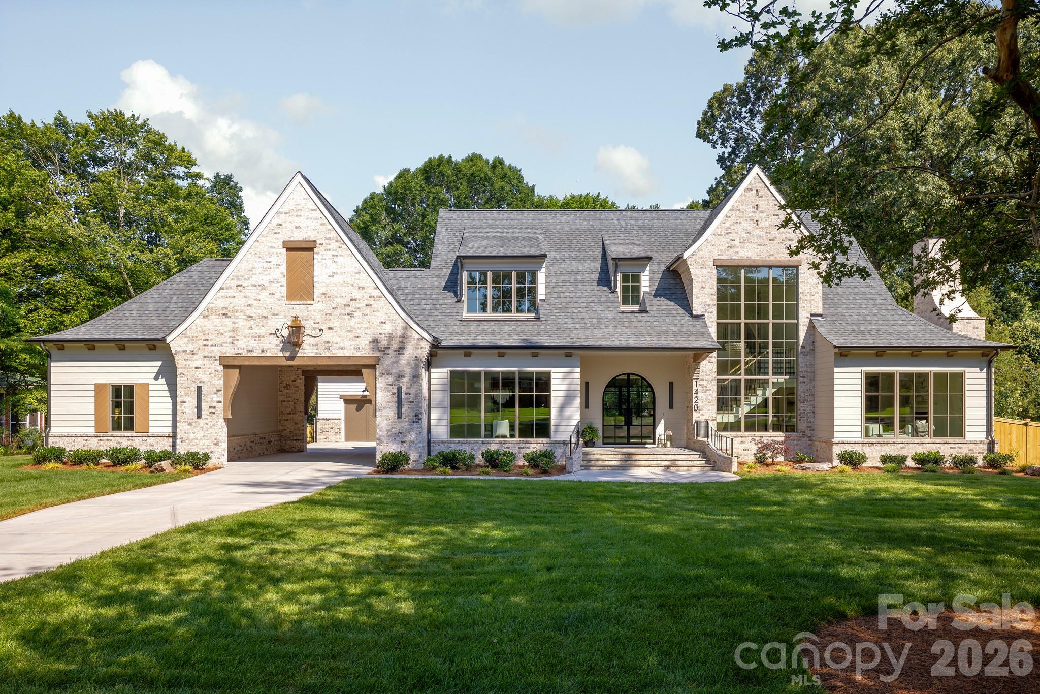 This elegant 5-bedroom, 5.5-bath home seamlessly blends luxury and comfort. The main level offers a sophisticated dining room perfect for formal gatherings, and a cozy living room ideal for relaxation with a sliding glass door leading you to your covered back porch overlooking a spacious, private backyard—perfect for outdoor enjoyment and plenty of space for a pool! The primary suite on the main level has an oversized walk-in closet and spa-like bathroom. This home offers a convenient flex room on the main level, a full bathroom, a mudroom with back door access, and side door access from the porte cochere. Upstairs, the home has a dedicated bonus room, a laundry room, and three additional bedrooms, each with its own bathroom, plus a convenient powder bath.