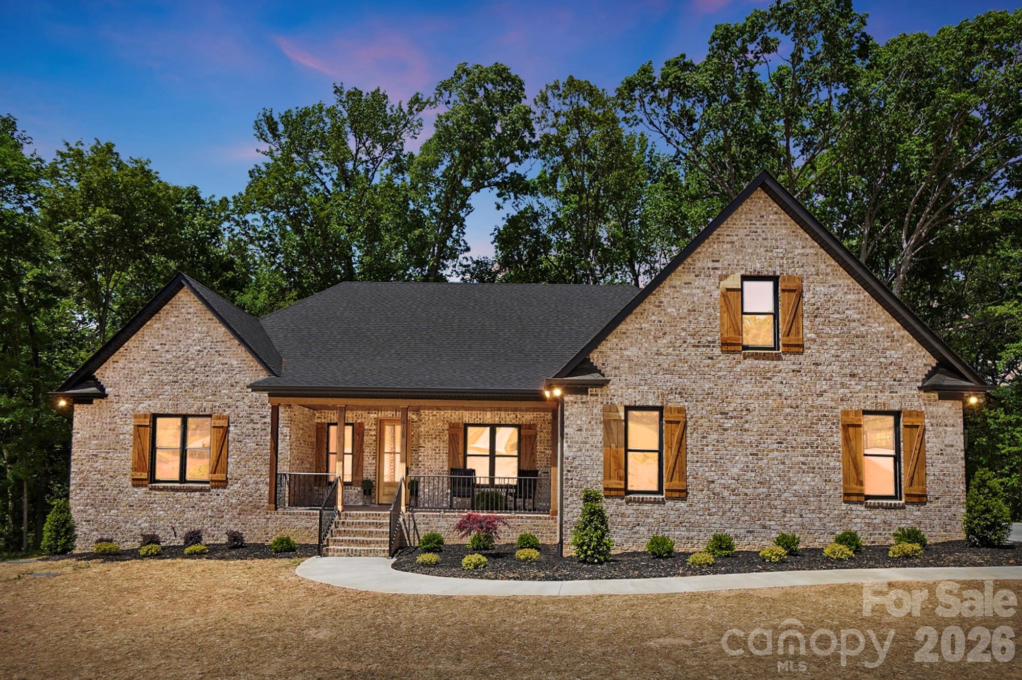 Welcome to 6109 Charity Drive in Marshville, NC—an exceptional custom home tucked away at the end of a quiet cul-de-sac in the highly sought-after New Salem/Piedmont school district.

Situated on over an acre, this beautiful property offers the privacy you’ve been looking for, with a wooded backdrop where no one can build directly behind you. From the moment you arrive, the inviting front porch sets the tone for the warmth and charm found throughout the home.

With 3,383 heated square feet, this thoughtfully designed home features an open floor plan perfect for both everyday living and entertaining. The stunning designer kitchen is the heart of the home, complete with a gas cooktop, oversized island, quartz countertops, and a stylish backsplash. One standout feature you’ll absolutely love is the incredible walk-in pantry—featuring cabinetry, quartz surfaces, a sink, and even a wine cooler—offering both beauty and functionality.
The spacious family room boasts soaring 12-foot ceilings and an electric fireplace, creating a bright and inviting gathering space. Just off the main living area, you’ll find a large dining room and breakfast area, providing plenty of room for hosting family and friends.

The primary suite is a true retreat with vaulted ceilings, a luxurious bath, and a generous walk-in closet. This home also offers 4 bedrooms, 4.5 baths, a dedicated office with a closet, and a huge bonus room—giving you the flexibility for work, play, and guests.

Step outside to the screened-in back porch featuring a cozy wood-burning fireplace—perfect for relaxing evenings year-round. The outdoor space is just as impressive with added concrete for extra parking and a walkway leading to the back porch.

Additional upgrades include a sealed crawlspace, spray foam insulation, tankless water heater, side-entry garage, designer lighting, and beautifully curated landscaping.

Located in a small community with no HOA, this home offers the perfect blend of luxury, privacy, and freedom.

This is a rare find—schedule your private showing today!

The builder has added additional concrete parking and has a great area to add an additional detached garage.
Plus he has a pool company come out and share where a pool could be placed.