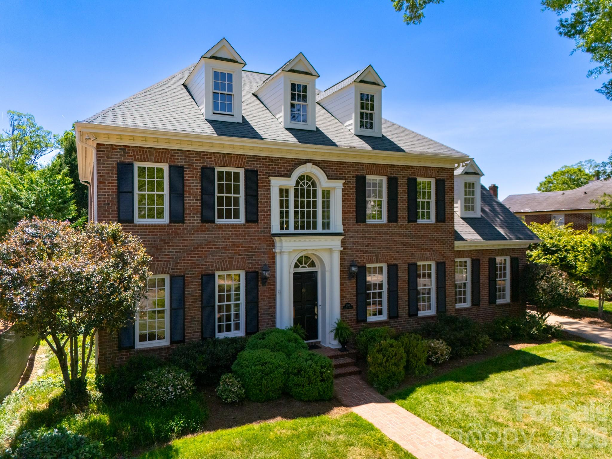 Set in the heart of Myers Park, this beautifully presented home offers the space, flexibility, and location buyers continue to seek. Filled with natural light, the thoughtful floor plan balances elegant entertaining with comfortable everyday living, offering generous rooms, timeless architectural details, and multiple spaces that can adapt as needs change.

The main level features soaring 10-foot ceilings, transom-topped windows, graceful arched openings, warm hardwood floors, and a spacious primary suite. Formal living and dining rooms provide classic entertaining spaces, while the open kitchen and breakfast area connect easily to the den for more casual gathering. The kitchen is equipped with dual Thermador ovens, a new Thermador gas cooktop, and a Sub-Zero refrigerator, offering a strong foundation for everyday use or future personalization. The home also features two staircases: a formal front staircase and a convenient back staircase off the den for easy access upstairs.

Upstairs, 9-foot ceilings continue the open feel, while four additional bedrooms offer incredible flexibility for residents, guests, work-from-home needs, exercise, and hobbies. A generous recreation room adds even more usable living space, and each upstairs bedroom has direct access to Jack and Jill bathrooms. One bedroom also includes a charming secret nook, perfect for reading, homework, or imaginative play.

The enclosed backyard, framed by classic brick walls, offers a low-maintenance outdoor retreat. A charming terrace and patio provide the perfect setting for dining and entertaining or simply unwinding—without the demands of a larger yard. The space is ideal as-is or offers potential for a pool and pool house, seamlessly integrated with the climate-controlled 2-car garage.
Above the garage sits a finished 362-square-foot space that adds exceptional versatility—perfect for an exercise room, home office, studio, or a future guest suite. Whether you need a dedicated workout space, a professional workspace, or accommodation for visiting family, this flexible area adapts to your lifestyle.

Located near top-rated schools and surrounded by the prestige, convenience, and lifestyle that define Myers Park, this home offers true walkability: to the greenway, Freedom Park, retail, and dining—all while being just minutes from Uptown, South End and Atrium hospital. With a flexible floor plan, exceptional lifestyle, and genuine value that allows for immediate ROI through smart updates, this home truly offers it all.

Recent updates include interior paint, new carpet throughout, new tile backsplash, new Thermador cooktop, and new electric driveway gate arm in 2026, exterior paint in 2025, roof in 2023, two furnaces in 2022, and two heat pumps in 2022.