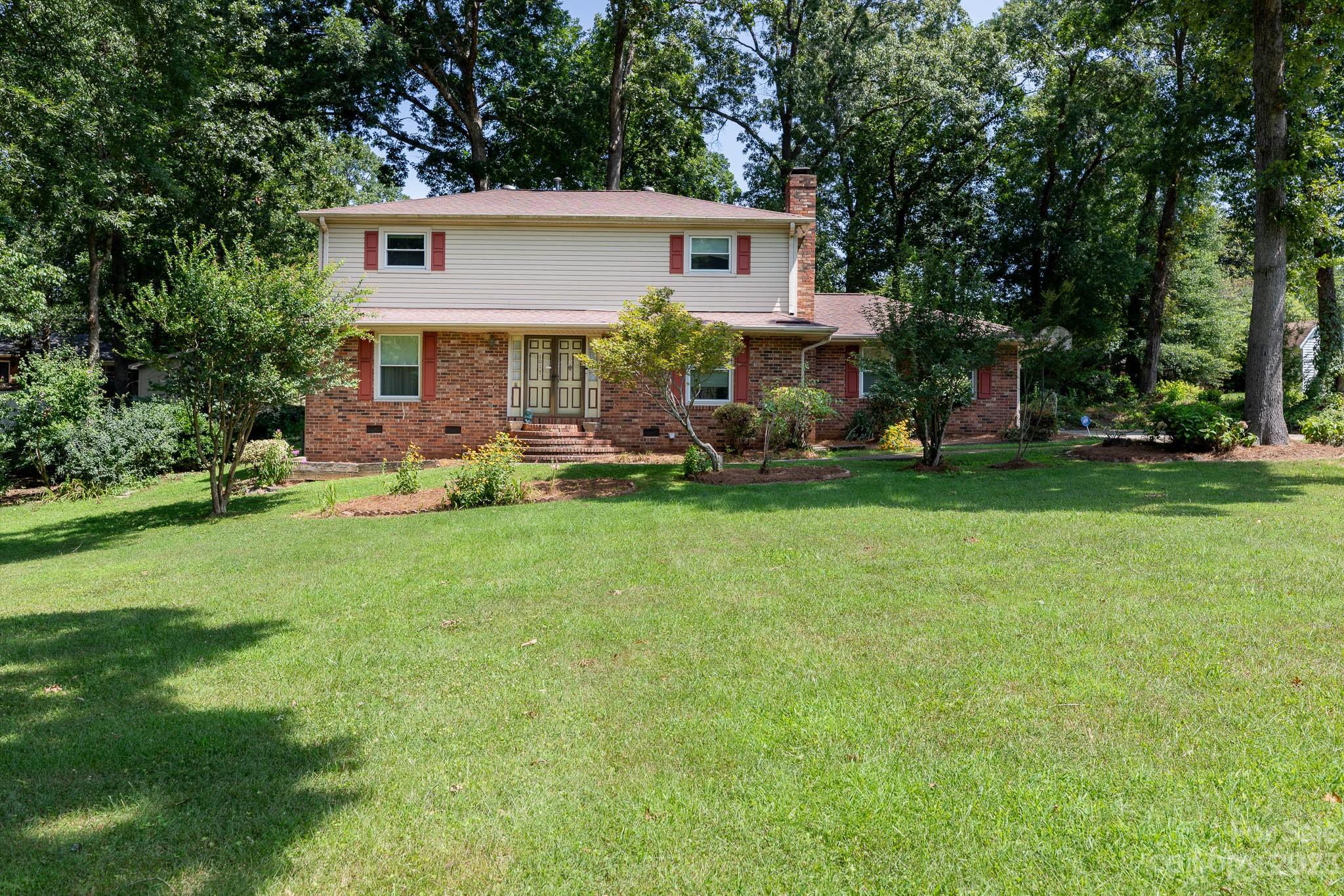 HUGE YARD! LOTS OF ROOM! EQUIPMENT UPDATES!  This home has been cared for and is ready for its new owners personal touches! You will love all the large rooms and space for entertaining!The custom kitchen has pull outs-lots of space.Appliances are fairly new and all stay;refrigerators in kitchen, carport, washer and dryer.  The cozy family room has fireplace and is open to the breakfast-keeping area.  Large open area to left of kitchen could be used for dining, flex space or office on main.  Upstairs spacious primary bedroom, walk in closet and double vanities.  Split bedroom plan up has 2 bedrooms on opposite end from primary and  has large guest bath.
Lots of beautiful plants and a mature fig tree!  Tons of space for playing, sports, basketball goal stays and shade tress galore.  The storage building stays.   Per seller:  2017 and 2018 new HVAC's systems with warranty to transfer w/ Morris Jenkins;2021 tankless water heater;newer faucets; newer windows,plumbing under house and roof!