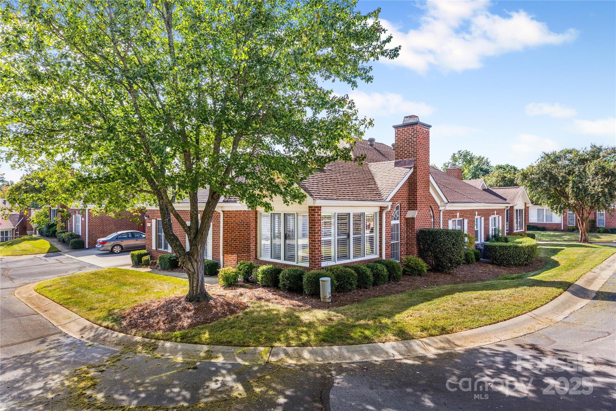 This low-maintenance brick condo offers a thoughtfully designed layout with style and comfort throughout. The open-concept main living area features durable LVP flooring, soaring vaulted ceilings, a cozy gas fireplace, and large windows with custom plantation shutters that flood the space with natural light.
A set of French doors opens to a bright, heated and cooled sunroom—perfect for relaxing or birdwatching year-round. A dedicated office/flex room offers versatility to fit your lifestyle.
The eat-in kitchen is ideal for any home chef, featuring granite countertops, stainless steel appliances, and abundant cabinetry. The split-bedroom floor plan ensures privacy, with a spacious primary suite boasting a tray ceiling, large walk-in closet, dual vessel sinks, and an oversized tile shower. A second spacious bedroom sits adjacent to an updated full bath with a vessel sink and glass-enclosed tub/shower combo.
Enjoy the convenience of a 2-car garage and a prime location just minutes from Stonecrest, Waverly, The Bowl at Ballantyne, top-rated schools, medical facilities, and major highways.