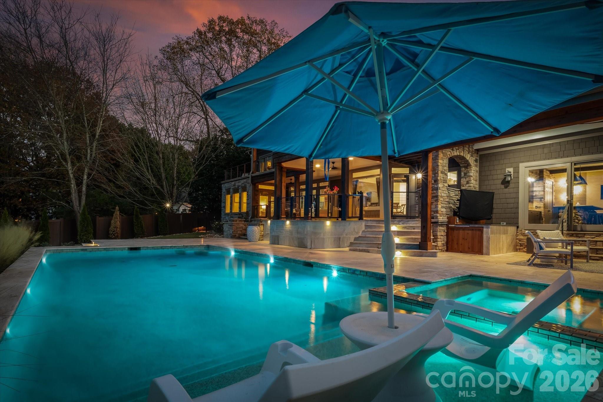 Live the ultimate Lake Norman lifestyle at 16407 Jetton Road — a private, gated waterfront retreat with sweeping year-round water views and NO HOA. This award-winning renovation has been elevated once again with a brand-new 2025 backyard oasis crafted by Pelican Pools, featuring a heated saltwater pool with tanning ledge, stunning hardscaping, and lush landscaping designed to make lakefront living effortless and scenic.
Inside, the home blends luxury, comfort, and thoughtful design. The main-level primary suite offers incredible water views and a recently renovated bathroom. Each secondary bathroom also features high-end custom tile designs, adding personality and quality throughout the home.

A welcoming two-story foyer sets the tone, leading into bright, open living spaces perfect for both everyday living and entertaining. The gourmet kitchen boasts Wolf/Sub-Zero appliances, a built-in Miele cappuccino machine, and generous prep and gathering areas. Unique lifestyle features include two laundry rooms, a dedicated kids’ workstation, and the signature full-size slide connecting the spacious playroom to the adult bonus room on the main level.

Outdoor living takes center stage with expansive porches on both levels to help capture postcard-worthy lake views. The recently renovated dock, sandy beach area, fenced yard, and horseshoe gated driveway complete the property’s unmatched functionality. A dog-washing station in the three-car garage adds day-to-day convenience.

Perfectly located just minutes from The Peninsula Golf & Yacht Clubs, shops and dining at Birkdale Village, and quick access to I-77 — this is lakeside luxury at its finest.