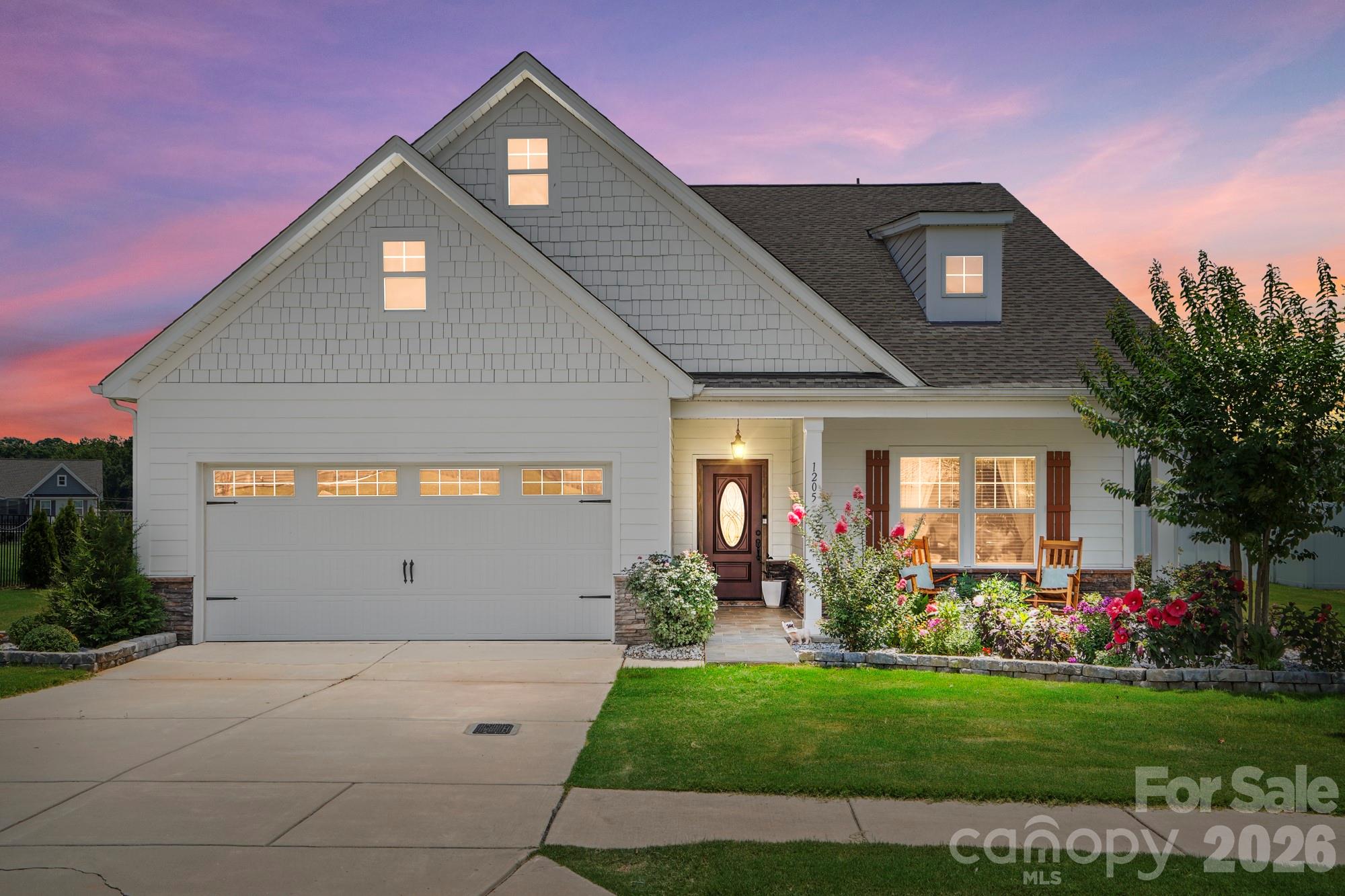 Welcome to 1205 Brooksland Place—where thoughtful design, modern finishes, and flexible living come together in one of Waxhaw's desirable Greenbrier community. Built in 2019, this beautifully maintained 3-bedroom, 3-bath home offers over 2,000 square feet of bright, open living space designed for both everyday comfort and effortless entertaining.

The heart of the home is the stunning chef's kitchen, featuring granite countertops, a large center island with seating, and abundant cabinetry, all overlooking the spacious living room and formal dining area. Whether you're hosting friends or enjoying a quiet evening at home, the open-concept layout creates the perfect gathering space.

The main-level owner's suite is a true retreat, complete with a private sitting area, spa-inspired bath, generous walk-in closet, and direct access to the screened porch—your own peaceful place to enjoy morning coffee or unwind at the end of the day. A secondary bedroom and full bath on the main floor provide flexibility for guests or a home office, while upstairs you'll find an oversized loft, an additional bedroom, and another full bath, offering the ideal setup for a media room, playroom, or private guest suite.

Situated on a spacious 0.27-acre homesite with a two-car garage, this home combines low-maintenance living with room to spread out. Conveniently located just minutes from charming downtown Waxhaw, shopping, dining, parks, and top-rated Union County schools, you'll enjoy the perfect balance of peaceful neighborhood living and everyday convenience.

Don't miss the opportunity to make this exceptional Waxhaw home yours—schedule your private showing today!
