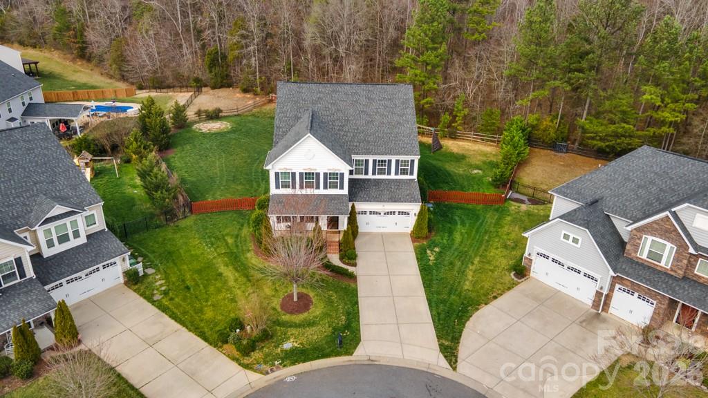 Welcome home to space, comfort, and connection in this beautifully maintained 5-bedroom, 3.5-bath 3-story home offering over 4,300 square feet on a quiet cul-de-sac home-site!

The inviting front porch sets the tone as you step inside to an open, light-filled floor plan designed for both everyday living and entertaining. The spacious great room with fireplace flows seamlessly into the kitchen, featuring a large island, abundant cabinetry, pantry, and an easy connection to the dining area. Whether hosting gatherings or enjoying a quiet evening at home, the layout offers flexibility and function.

The main level includes a dedicated home office and sunroom. Upstairs, the generous primary suite provides a private retreat with a well-appointed bath and walk-in closet. Three additional bedrooms and loft area offer ample space for family or guests, while the third-level bonus/media room and yet another bedroom creates the perfect setting for movie nights, gaming, or a private getaway.

Outdoor living is just as appealing, with a rear deck overlooking the fenced backyard and firepit, ideal for grilling, relaxing, or entertaining. New garage door opener just installed (March 2026).

Neighborhood amenities: Community pool, playground, sport courts, and sidewalks.  This home offers the perfect balance of tranquility and accessibility, just minutes from Charlotte, Pineville, and Ballantyne.