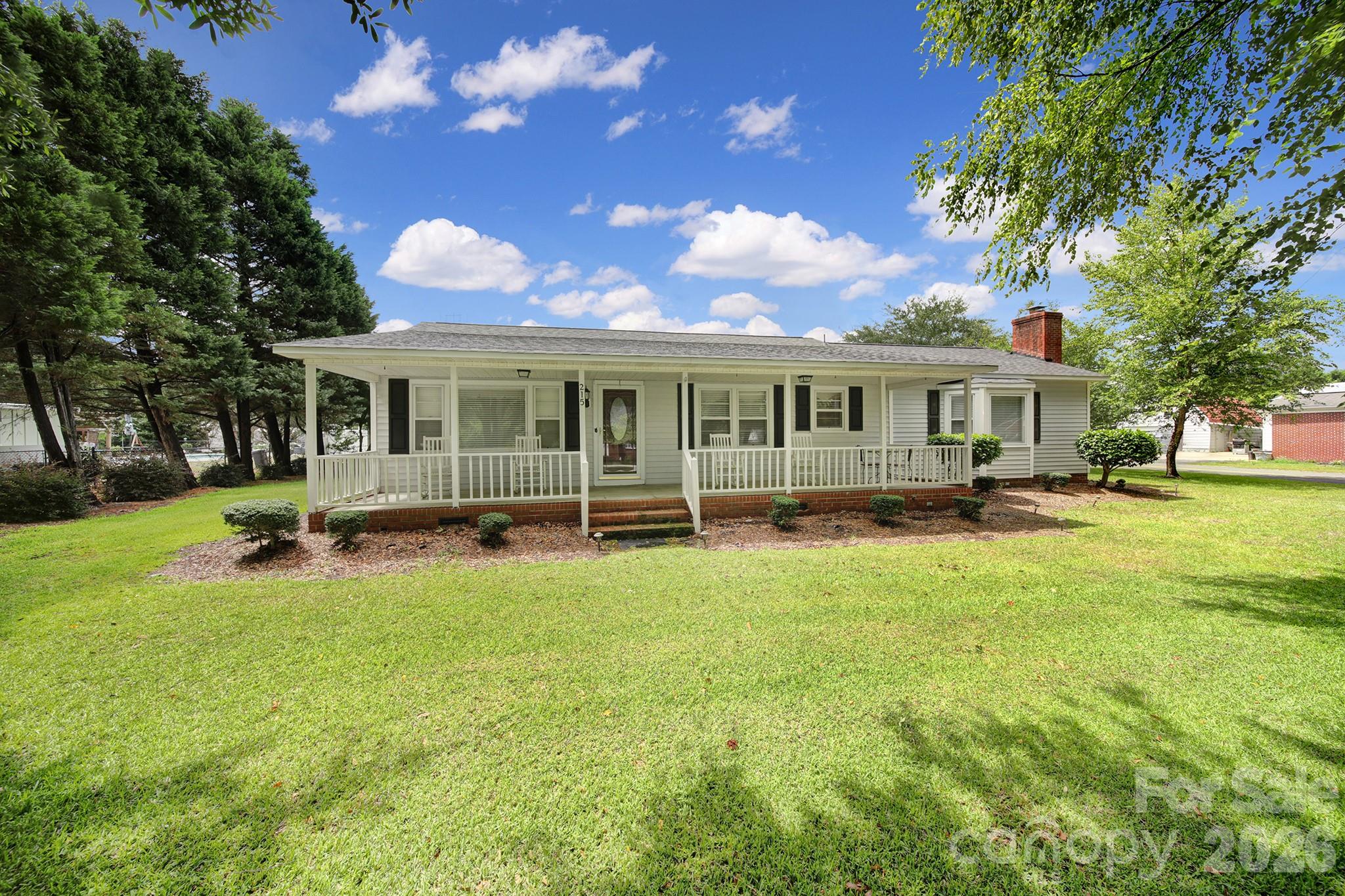 Welcome to 215 W Steven’s Dr in Kershaw, SC—a property that truly stands out for its exceptional care, thoughtful updates, and incredible outdoor amenities. This well-maintained 3-bedroom, 2-bath home offers the perfect blend of comfort, functionality, and curb appeal, making it an ideal choice for anyone looking for a move-in-ready home with extra space for hobbies, vehicles, and outdoor living.  Inside, you'll find a warm and inviting floor plan designed for everyday living and entertaining alike. The pride of ownership is evident throughout, with every detail carefully maintained over the years. Major updates provide added peace of mind, including a brand-new HVAC system installed in 2026 and a roof that is only six years old.  Step outside and prepare to be impressed. The beautifully landscaped yard is a true highlight of the property, featuring colorful flowers, mature plantings, and a full irrigation system to keep everything looking its best with ease. Whether you're enjoying your morning coffee, hosting family gatherings, or simply relaxing after a long day, the outdoor space offers a peaceful setting you'll love coming home to.  Need room for vehicles, projects, or recreational equipment? This property delivers! In addition to the attached two-car garage, you'll find a dedicated workshop/shop area perfect for hobbies, woodworking, storage, or a home-based workspace. As an added bonus, there's a covered RV shed, providing valuable protection and storage for your RV, boat, camper, or other outdoor toys.  Homes that combine this level of maintenance, recent updates, beautiful landscaping, and versatile outbuildings are hard to find. If you've been searching for a property that offers both comfort and practicality, this is one you won't want to miss