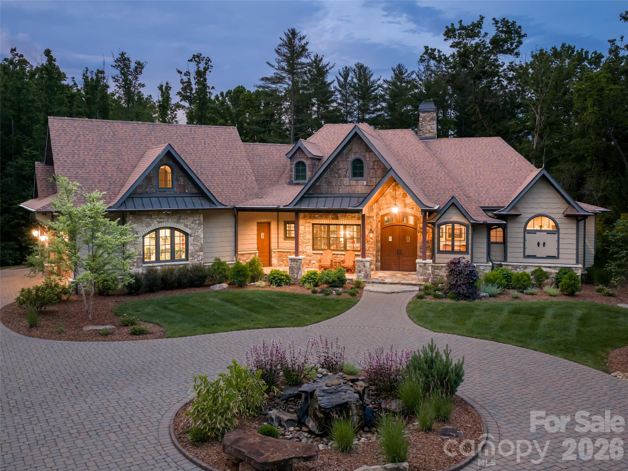 A rare opportunity to own a private estate in Fletcher offering exceptional craftsmanship, privacy, and convenient access to both Asheville and Hendersonville. Welcome to 151 Bridgewater, set on 7.79 acres in Fletcher’s gated Bridgewater community. Custom built in 2016, this beautifully designed home offers 4,113 square feet of thoughtfully curated living spaces filled with architectural detail and timeless finishes. The great room showcases vaulted ceilings with stained tongue-and-groove wood and exposed beams, while expansive bi-fold doors open seamlessly to inviting outdoor living spaces. The 2023 kitchen renovation is a standout, featuring leathered quartzite countertops and backsplash, custom cabinetry, premium Miele appliances, and a stunning 117-inch island with walnut waterfall edge. Outdoors, enjoy the beauty and privacy of the property from the heated saltwater pool to the covered entertaining area with a wood-burning fireplace, retractable screens, surround sound, and a flagstone fire pit. The detached 1,208-square-foot heated and cooled 3-bay garage/workshop offers 2 lifts, RV hookup, and incredible flexibility.