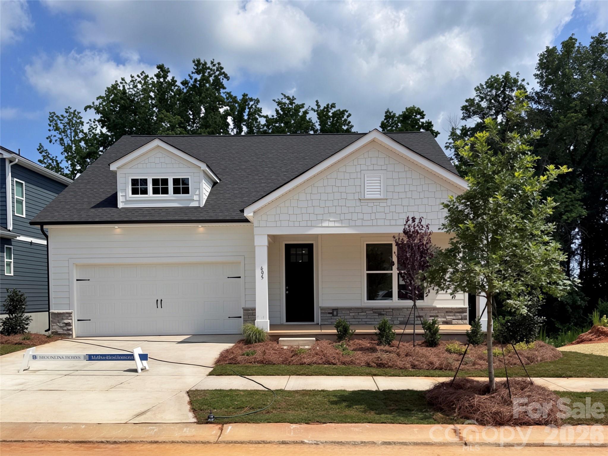 Welcome home to The Rankin, a thoughtfully designed one-story retreat where everyday living feels easy and intentional. With 3 bedrooms and 2 bathrooms on the main level, this craftsman-style home is the perfect blend of warmth, functionality, and timeless style. At the heart of the home, the chef-inspired Kitchen invites connection—featuring 42" maple-almond cabinetry with brushed gold hardware, a gas range, quartz countertops, and a seamless flow into the Great Room and Dining Room. Whether you’re preparing a quiet weeknight dinner or hosting friends, this open layout makes it effortless to be together. Just off the Kitchen, tucked away for privacy, the Owner’s Suite offers a serene space to unwind, complete with dual vanities, a beautifully tiled walk-in shower with a semi-frameless glass door, and a spacious walk-in closet that truly feels designed for real life. Two additional bedrooms are located at the front of the home and share a full bath with a convenient tub/shower combination—perfect for guests, family, or a home office. Downstairs, the living space continues with a full, finished walk-out basement featuring 9-foot ceilings, an additional bedroom, and a full bathroom—ideal for guests, multigenerational living, or a private retreat. This level also includes unfinished storage space, offering flexibility and room to grow while keeping everything neatly organized. Start your mornings on the covered front porch with a cup of coffee, or end the day relaxing outdoors after parking in the generous two-car garage. Every space in The Rankin is designed to feel comfortable, welcoming, and easy to enjoy. Located in a charming new single-family home community in Cramerton, North Carolina with only 39 homesites, you’ll be surrounded by natural beauty, wooded views, and small-town charm—without sacrificing convenience. 

Just minutes from Cramerton’s riverside town center and nearby Belmont’s dining, shopping, and pubs, residents enjoy a vibrant small-town lifestyle with easy access to Uptown Charlotte’s world-class amenities.

**Photos & Tour are Representational**